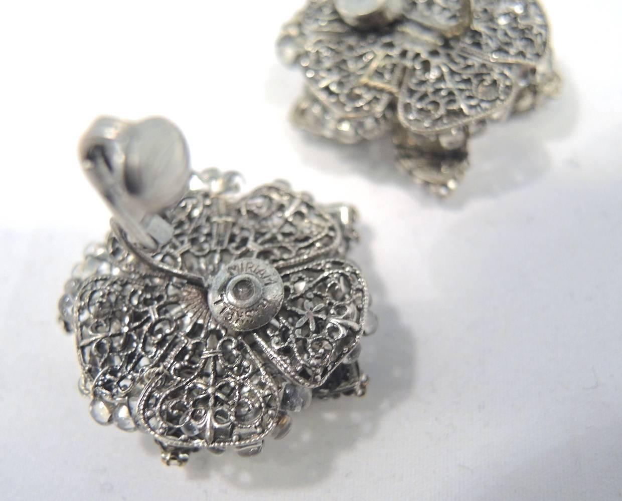 These vintage signed Miriam Haskell earrings features a floral design with crystals in a silver-tone setting.  In excellent condition, these clip earrings measure 1-1/8” x 1-1/8” and are signed “Miriam Haskell”.