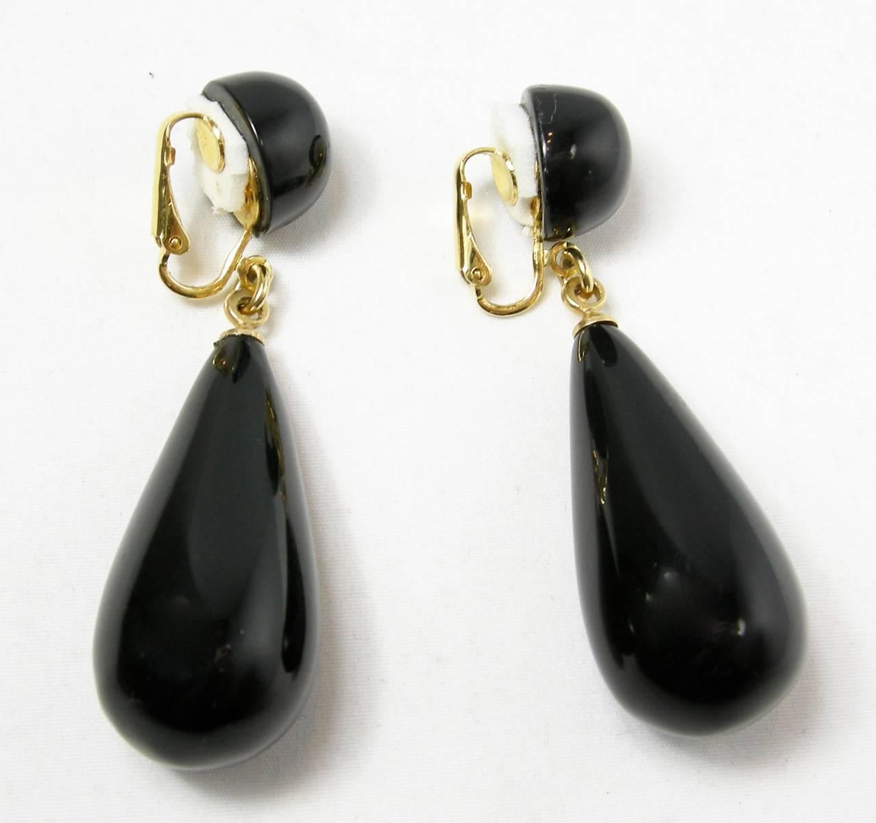 Perfect for anytime are these dangling clip earrings from Kenneth Jay Lane.  These black teardrop earrings measure 2-1/4” x 3/8” in a gold tone setting.  They are signed “Kenneth Lane” and in excellent condition.  