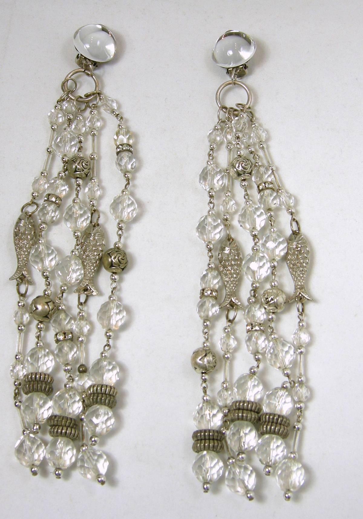 These clip back shoulder duster earrings feature dangling large sparkling Lucite beads with thin silver tone fish.  The Lucite has silver connectors and beads that decorate the earrings. They measure 6-1/2” x 2” and are in excellent condition.