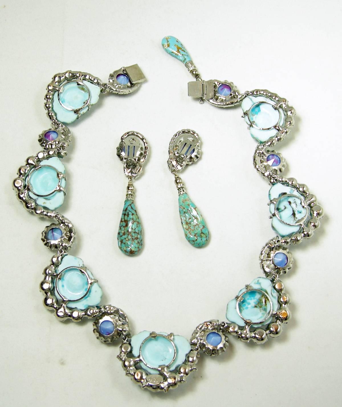 This is a wonderful “one-of-a-kind” necklace and earrings set made for Jeweldiva.  It has a scalloped design with 7 faux rock turquoise stones segments surrounded with brilliant crystals.  In-between each scallop segment are pronged set merlot