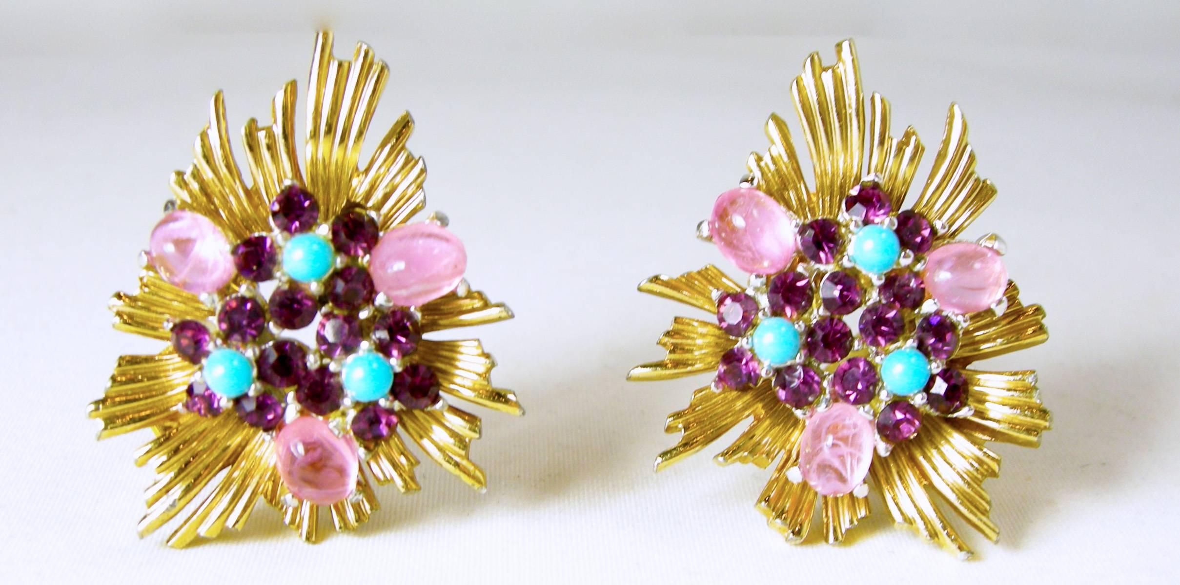 These signed “Boucher” spray earrings consist of pink art glass with purple rhinestones and turquoise cabochons that are set in a gold tone setting. They measure 1-1/2” x 1” and are in excellent condition.
