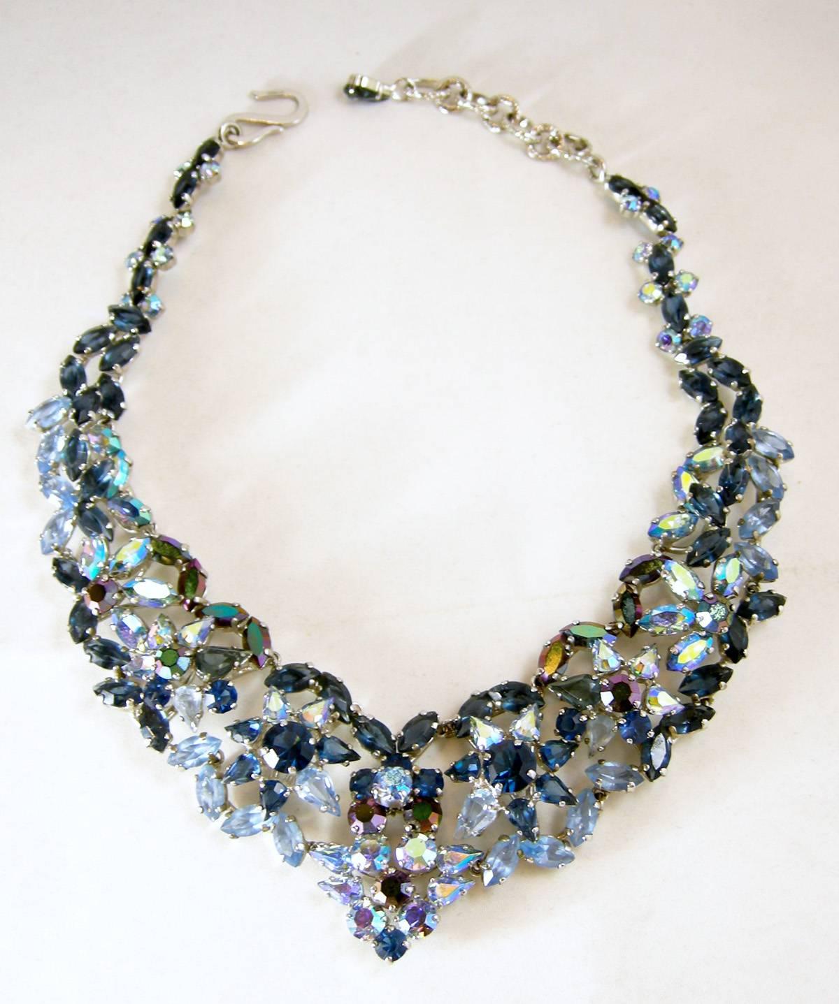This is a gorgeous Christian Dior 1960s necklace created with a 3-dimensional design with light and dark blue crystals in-between two rows of marquis shaped crystals.  The center has a flower design of dark blue crystal with a light blue center