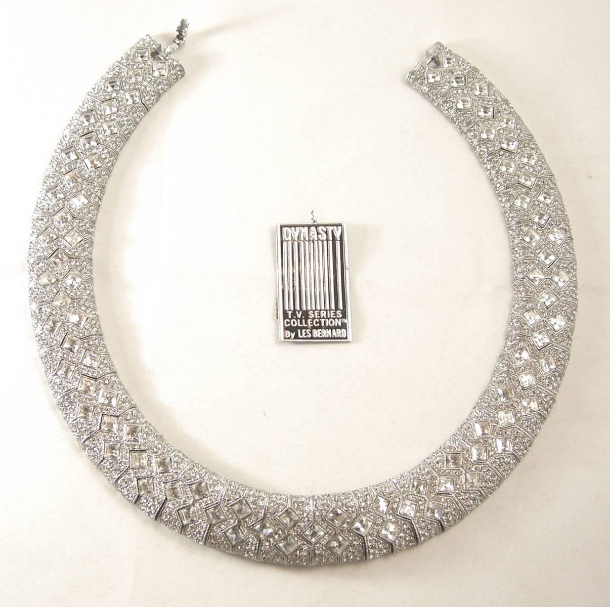This is an amazing Les Bernard collar Necklace that is part of the Dynasty tv series collection. It is silver plated with crystal pave and shines like real diamonds..  The Glistening necklace measures 17” x 3/8” and has a fold over clasp. It is