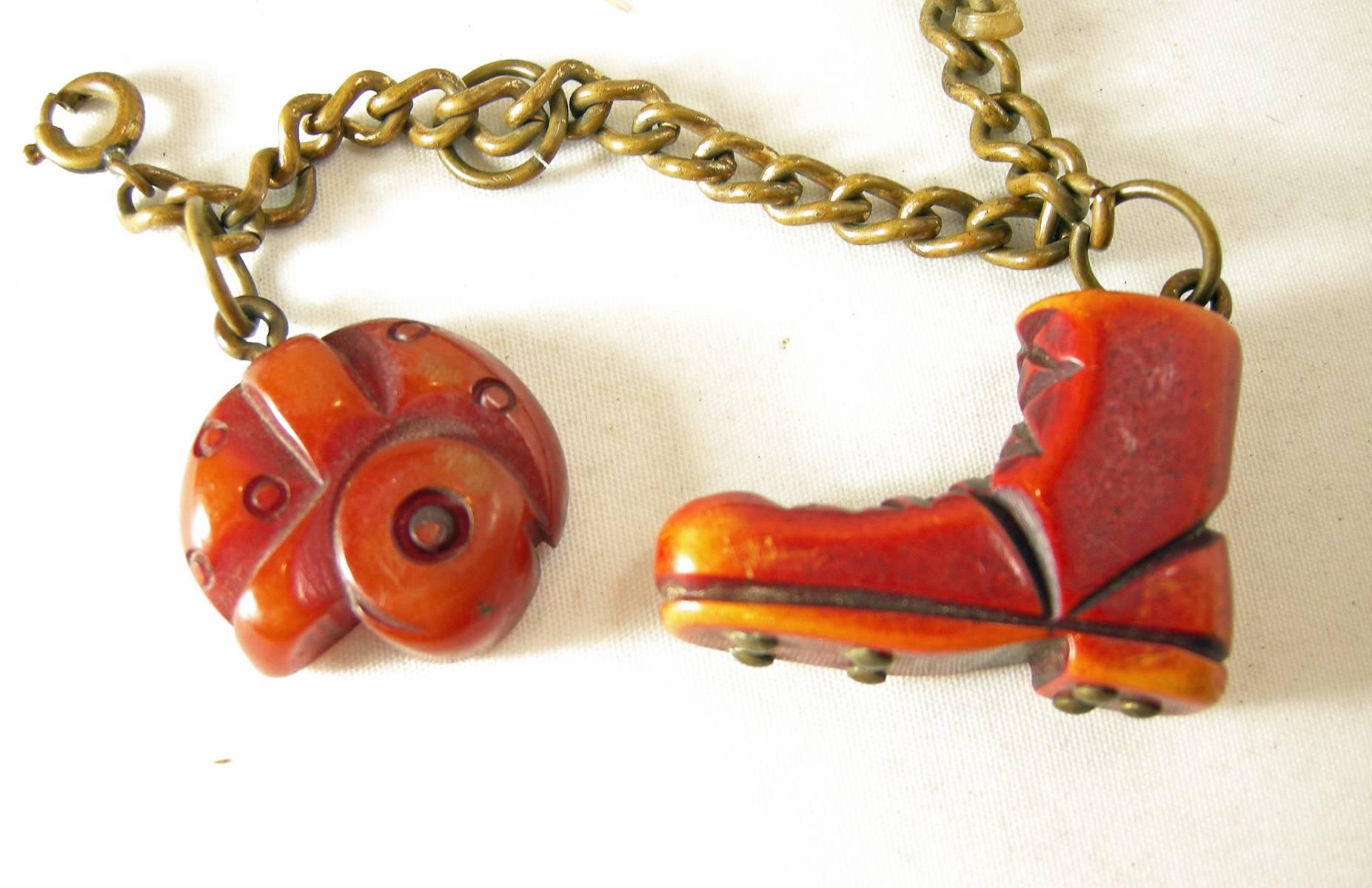 There are two rare Bakelite charms left on this bracelet.  One is red football shoe and the other is a football helmet.  The Bakelite is nicely carved and is rare to find. As we all know, these charms use to sell for $400 each and two are missing