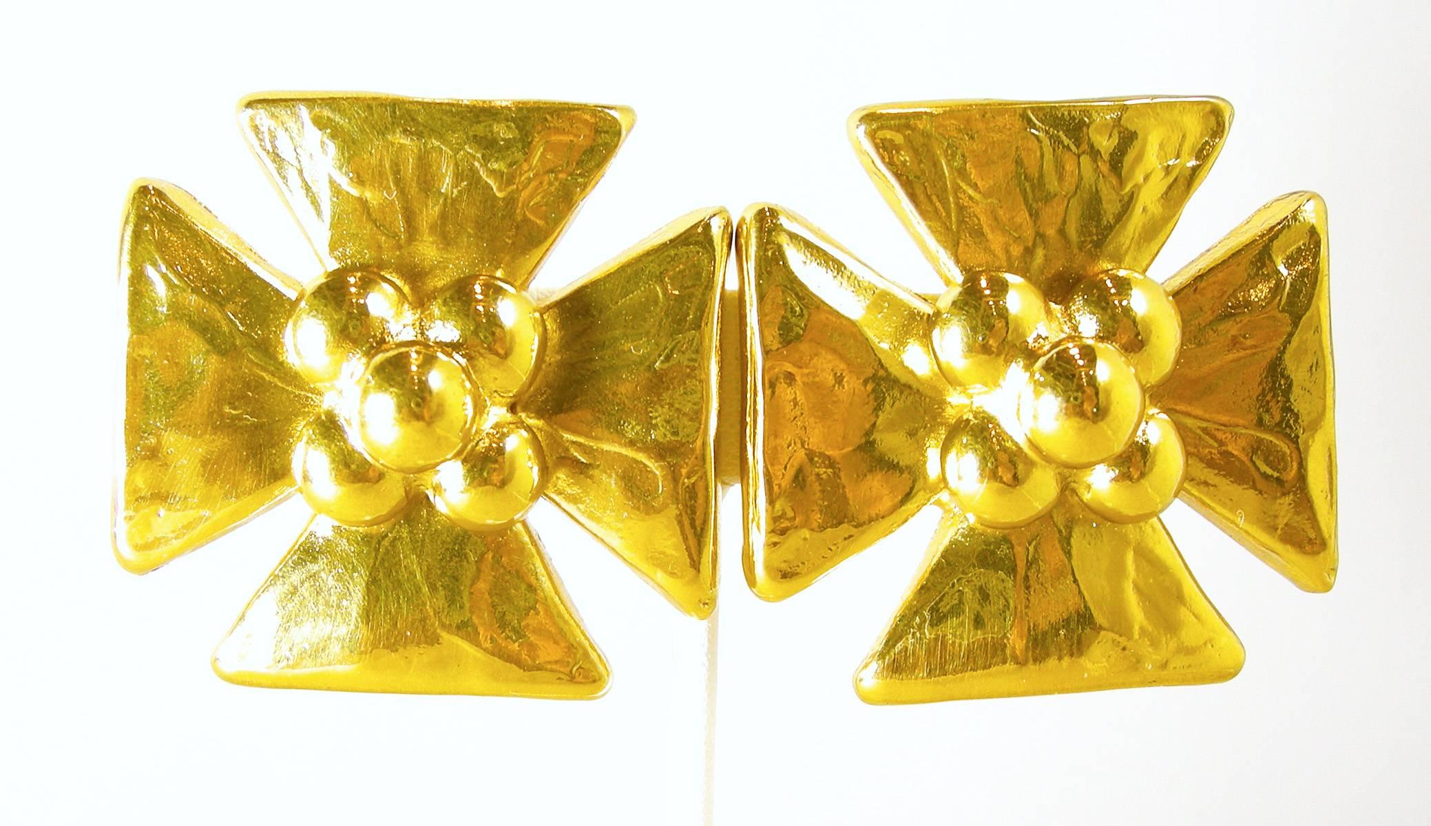 These are a pair of authentic vintage YSL clip templar cross earrings. They are massive and are in a gold tone setting. They measure 1-3/8” x 1-3/8”. They are signed “YSL Made in France”. They are in excellent condition.