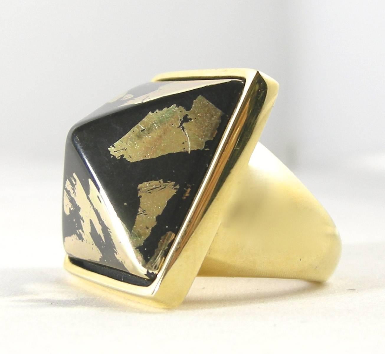 This unusual ring by Kenneth Jay Lane is rare and forms a Pyramid giving an illusion of gold melting into black creating a mystical design.  It is in a gold tone setting and measures 1-¾” x 1”.  It is signed “Kenneth Lane” and can fit up to a size 8
