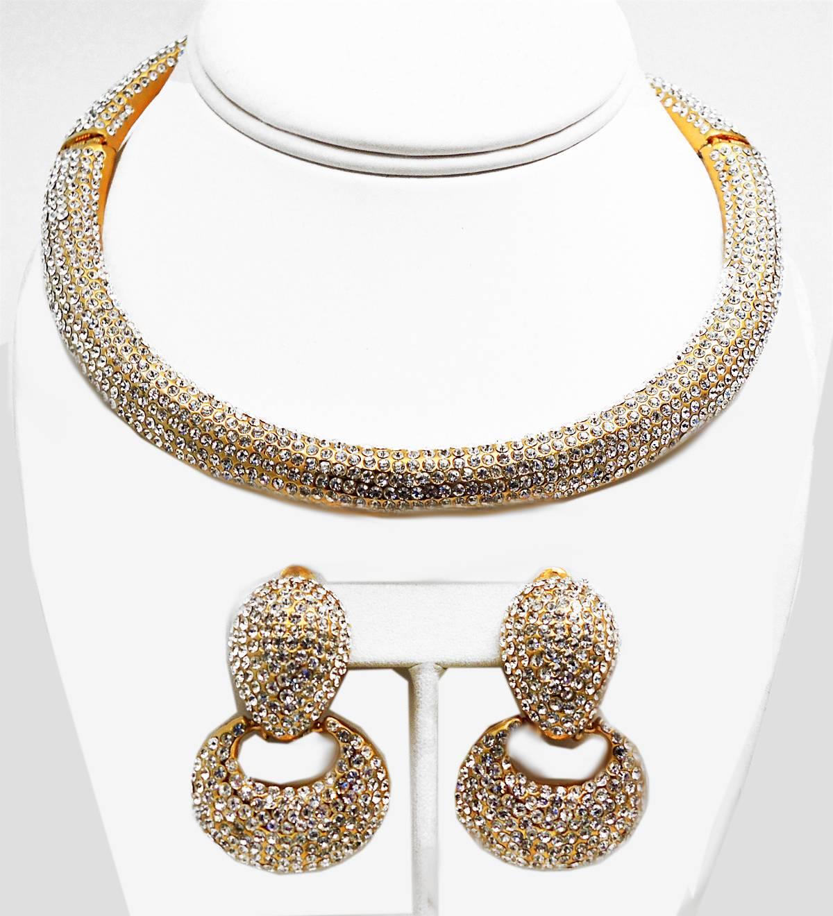 Jarin is a jeweler’s jeweler!  This is a vintage signed “JARIN NYC” set, which are extremely hard to find and this stunning set is no exception!  It has striking clear crystals in a gold-tone setting. The Collier De Chien necklace has a hinged