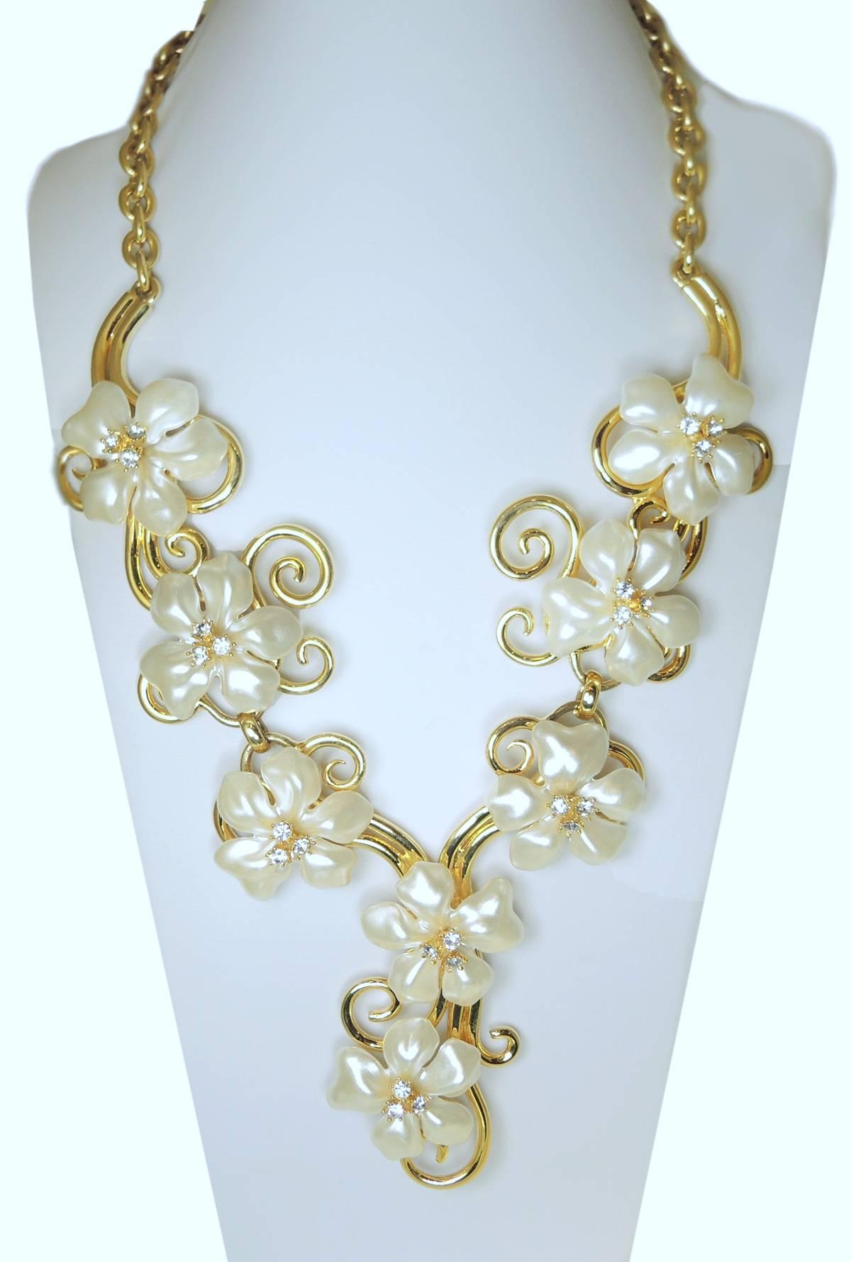 This is a showstopper necklace by Kenneth Jay Lane with faux pearls with crystal accents in a swirling gold-tone setting.  This stunning statement piece measures 14’ x 2” with a lobster clasp. It is signed “Kenneth Lane” “Made In The USA” and is in