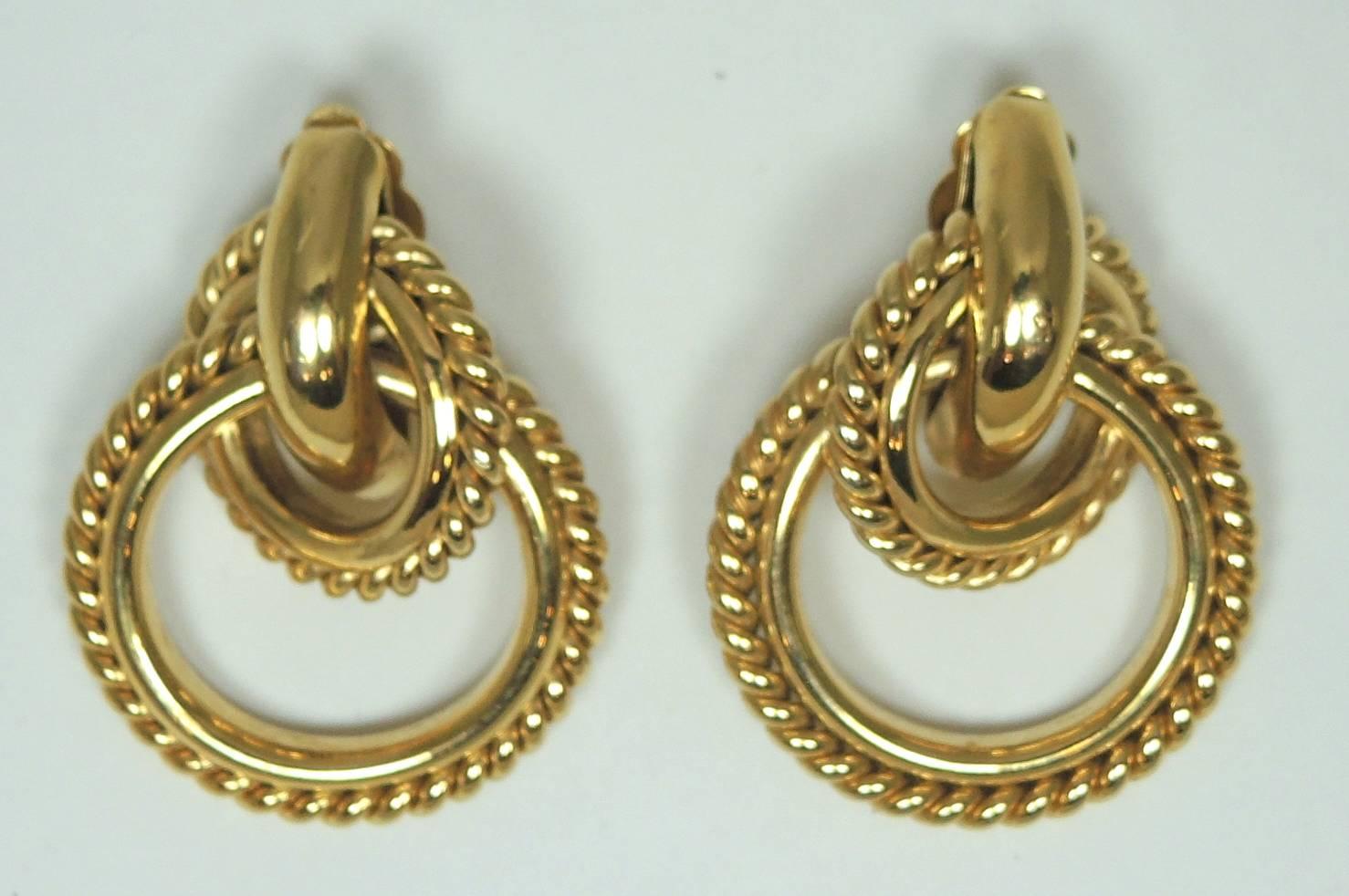 These stunning Givenchy earrings feature a double hoop design in a gold tone setting.  They measure 2” x 1-1/2” and are signed “Givenchy”. They are in excellent condition.