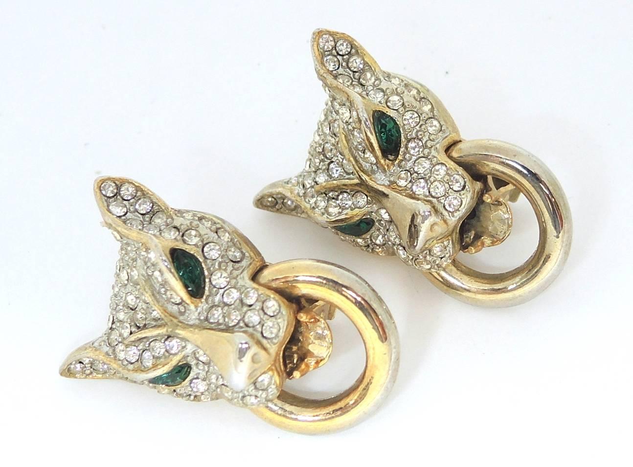 These vintage panther earrings is designed with green crystals eyes surrounded by clear crystal in a gold-tone setting.  These clip earrings measure 2” x 1-1/4” and are in excellent condition.