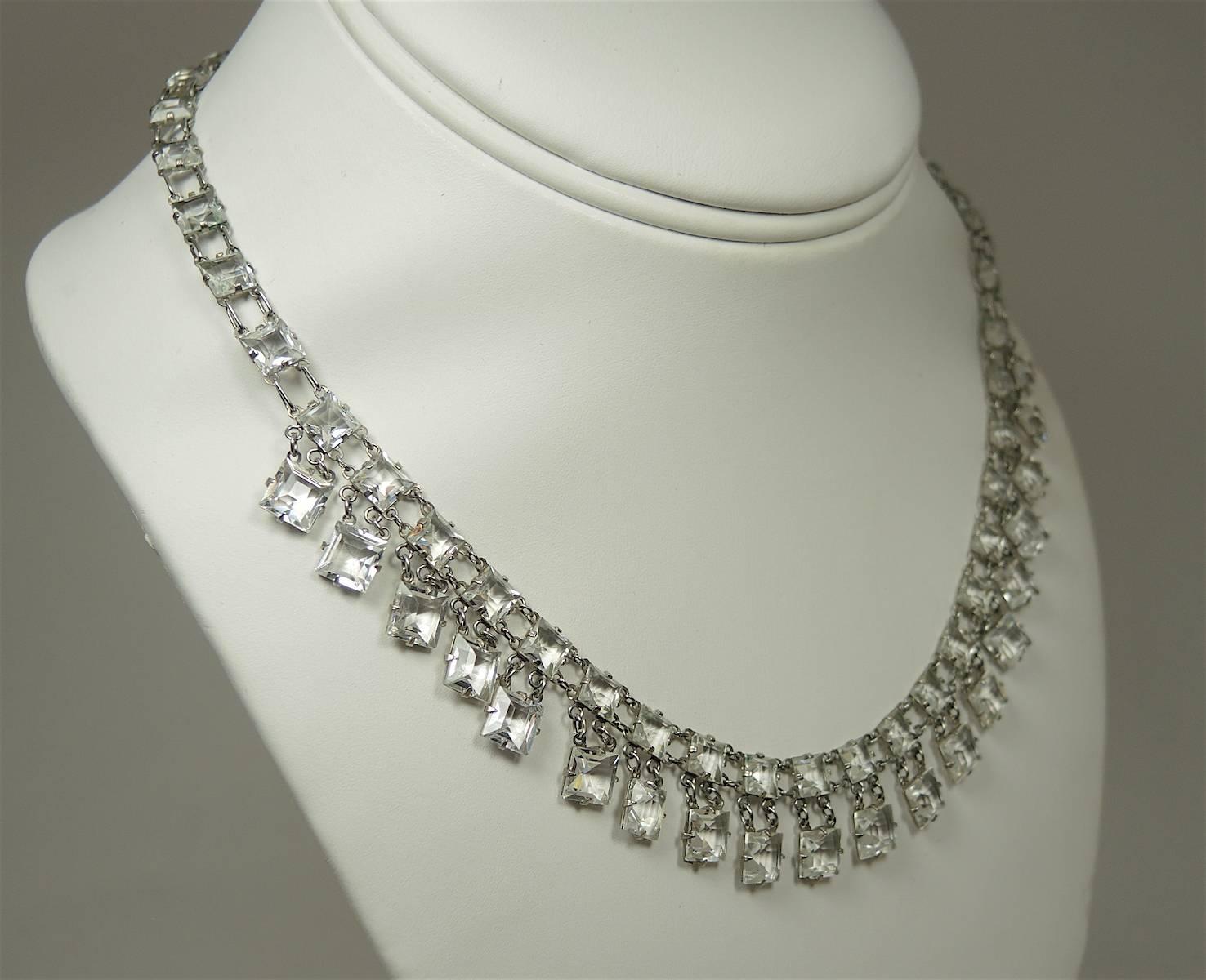 This lovely vintage Art Deco 1930s necklace features clear crystals in a sterling silver setting.  This necklace measures 15” x 1/2” with a spring ring clasp and is in excellent condition.