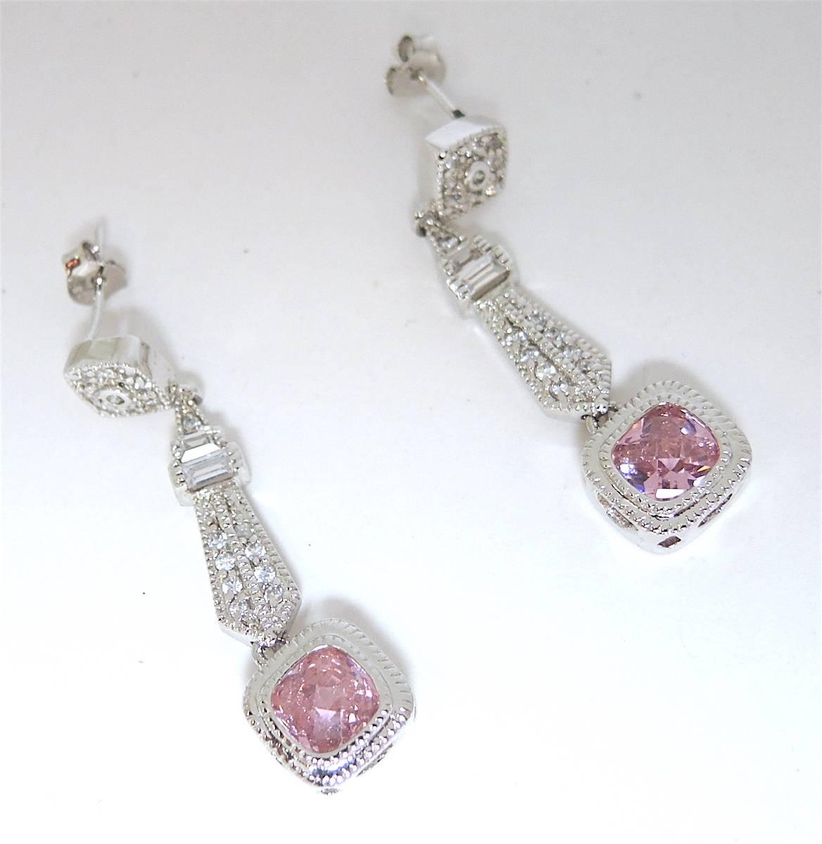 These beautiful drop earrings feature rich pink and clear crystals in a sterling silver setting. These pierced earrings measure 1-1/2” x 1/4” and are in excellent condition.    
