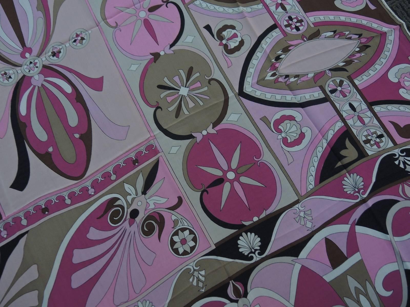 This Emilio Pucci scarf has the multi-color blend of pink, black, white and brown colors that Pucci is famous for.  This lovely 100% silk scarf signed “Emilio” is a must have for your collection of scarves!  It measures 2’9” x 2’9” and is in