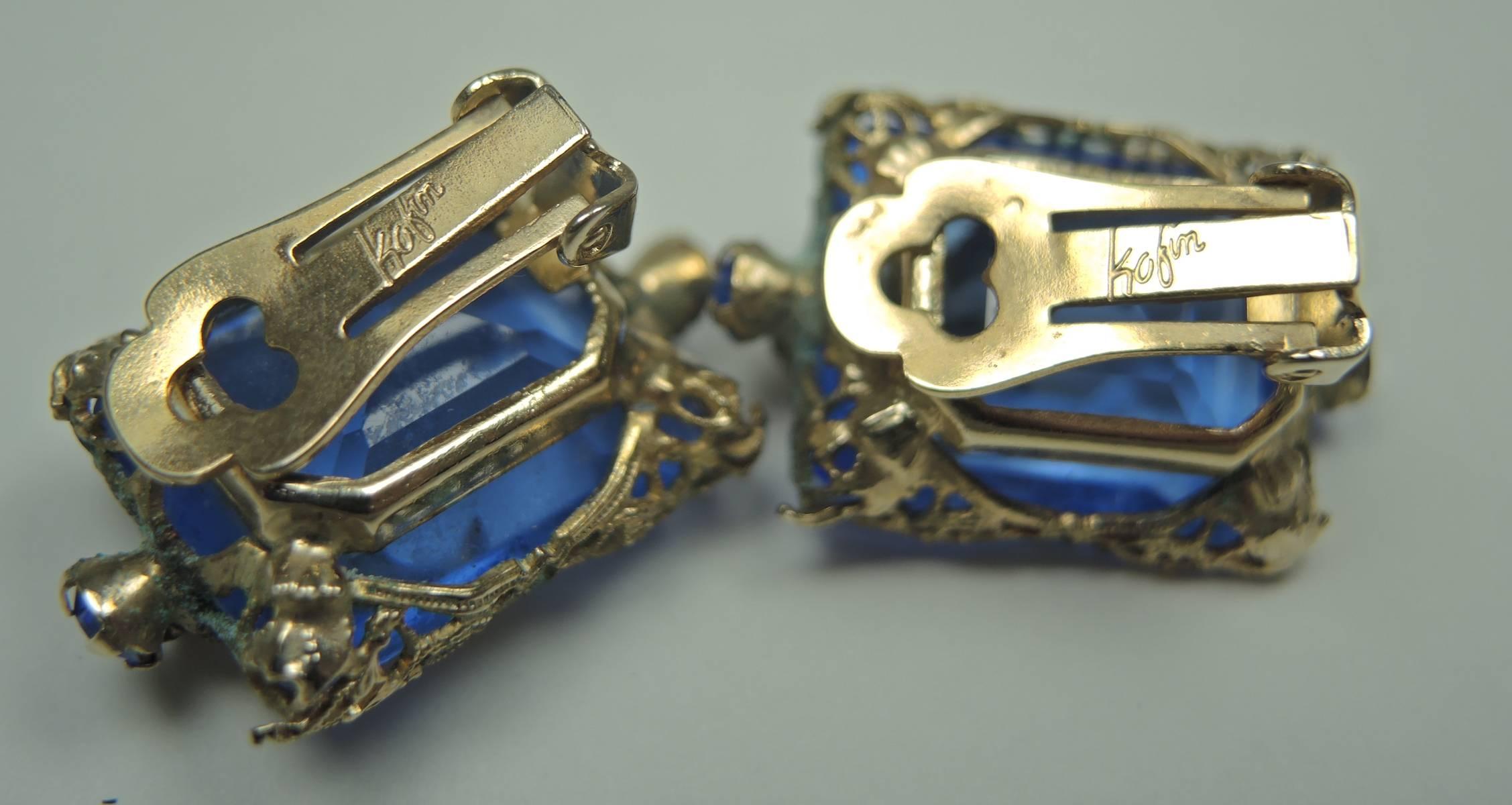 Kafin makes stunning jewelry and we thought, at first glance, they might be real cause they just have that money look.  These beautiful clip earrings feature a rectangular faux faceted sapphire stone with a golden floral leaf in the front. The