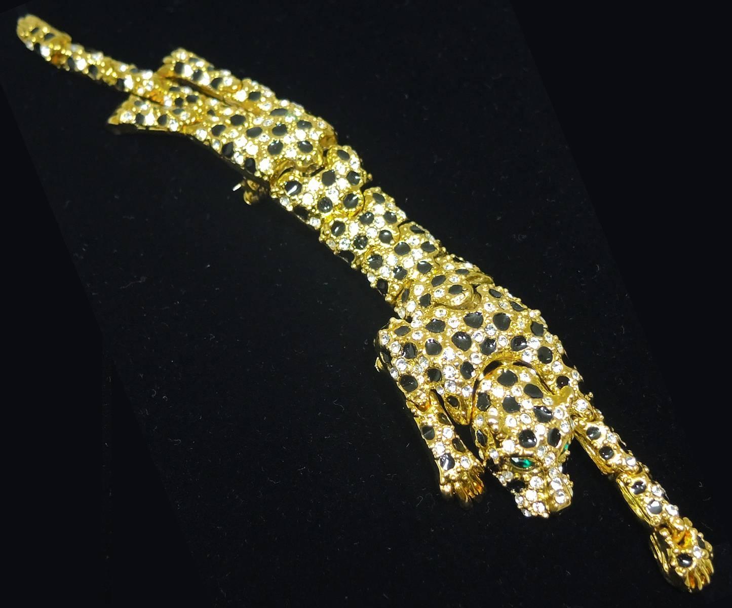 This leopard brooch is always sought after and I love finding them!  The entire body is articulated into segments, which make this brooch very flexible. It has clear rhinestones with black enamel spots. The eyes are made with green rhinestones. This