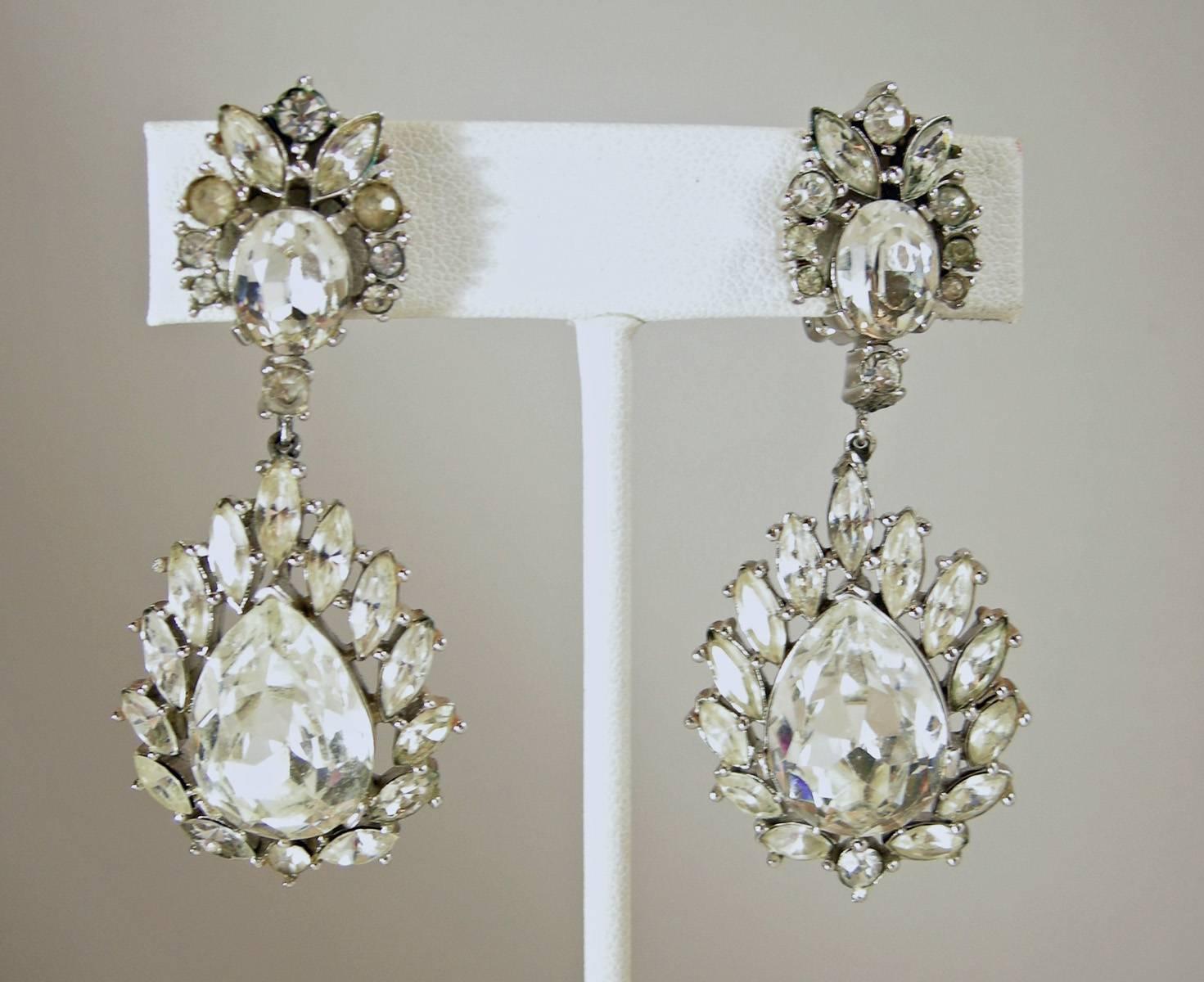 These vintage 1950s clip Trifari earrings are perfect for the holidays.  They are designed with an oval rhinestone on the top surrounded by various shaped rhinestones.  It then is connected to a beautiful teardrop center rhinestone surrounded with