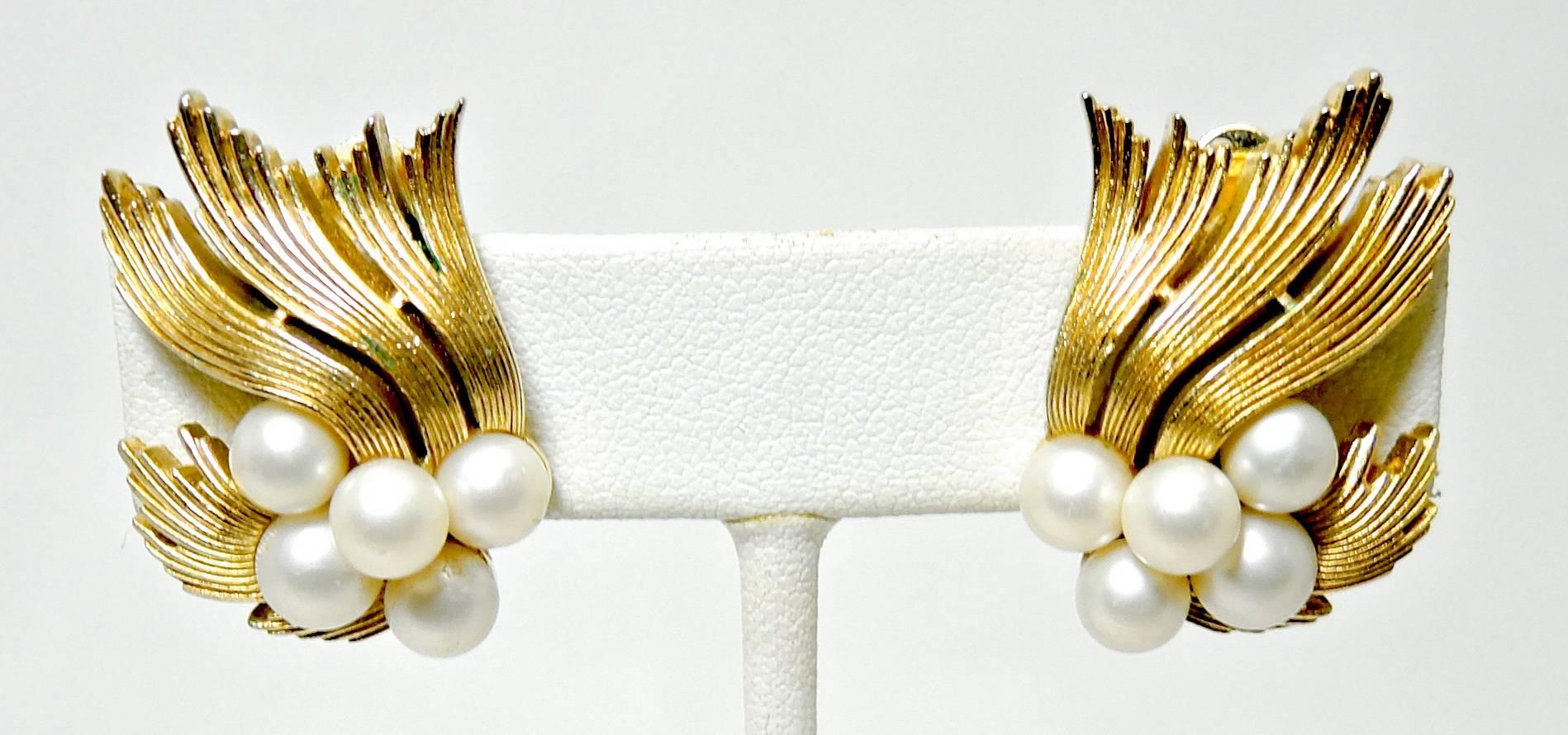 These are a pair of Trifari’s classic gold tone earrings that have their famous ribbons and faux pearls design. These clip earrings measure 1-1/8” x 1” and are signed “Trifari”. They are in excellent condition.