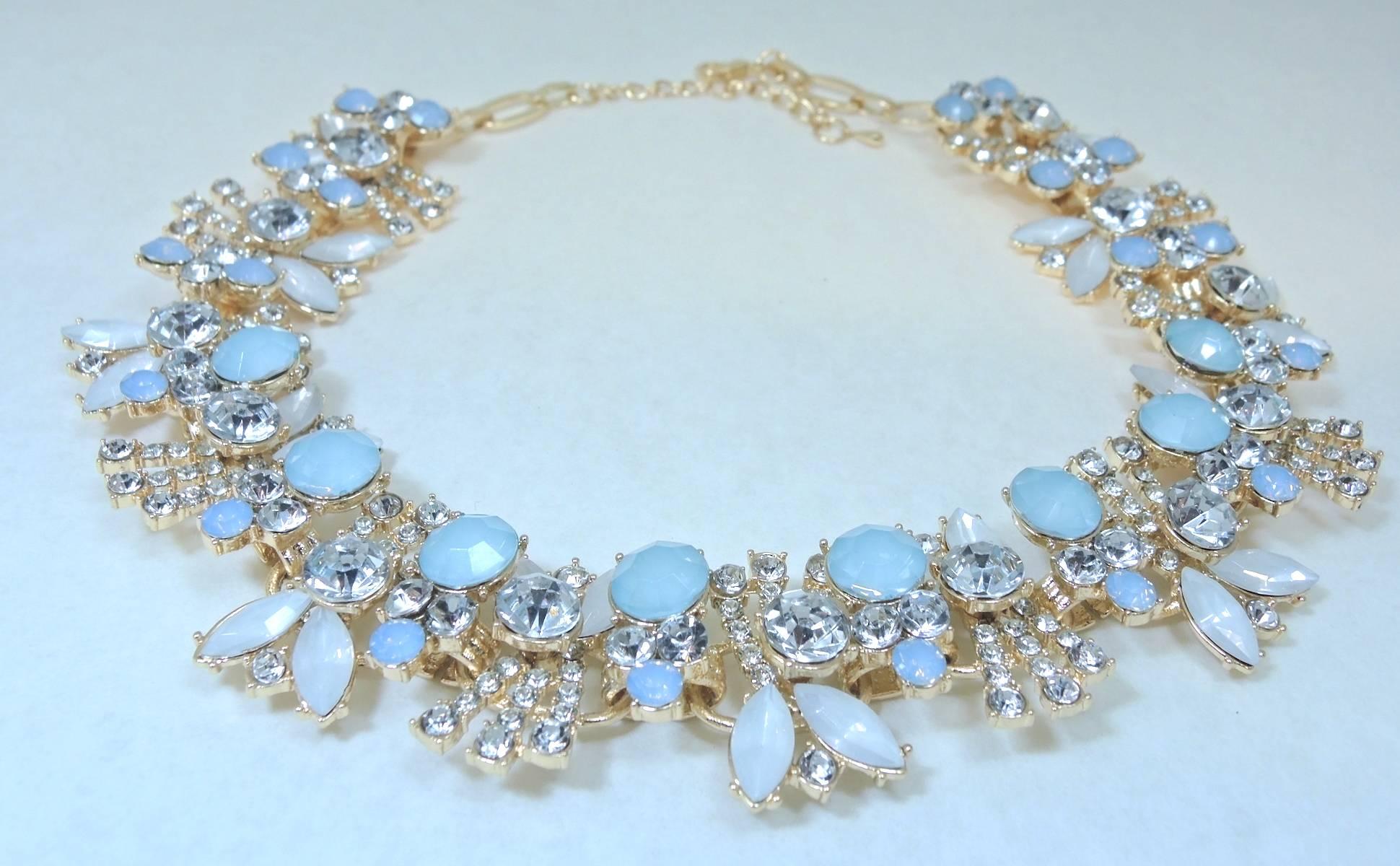 This lovely necklace features a floral leaf design of light blue, white & clear rhinestones.  It is set in a rose gold tone setting and has a lobster clasp. This necklace measures 22” x 1-1/2” and is in excellent condition.