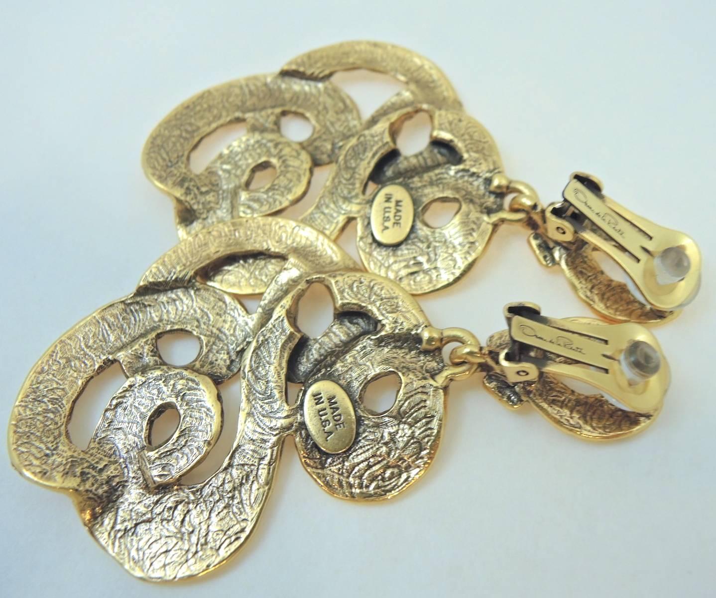 These long Oscar De La Renta clip earrings are very chic and can be worn with a multitude of necklaces.  They are made with a carved and swirl motif design and measure 3-1/2 x 2” in a gold tone setting. They are signed “Oscar De la Renta” “Made In