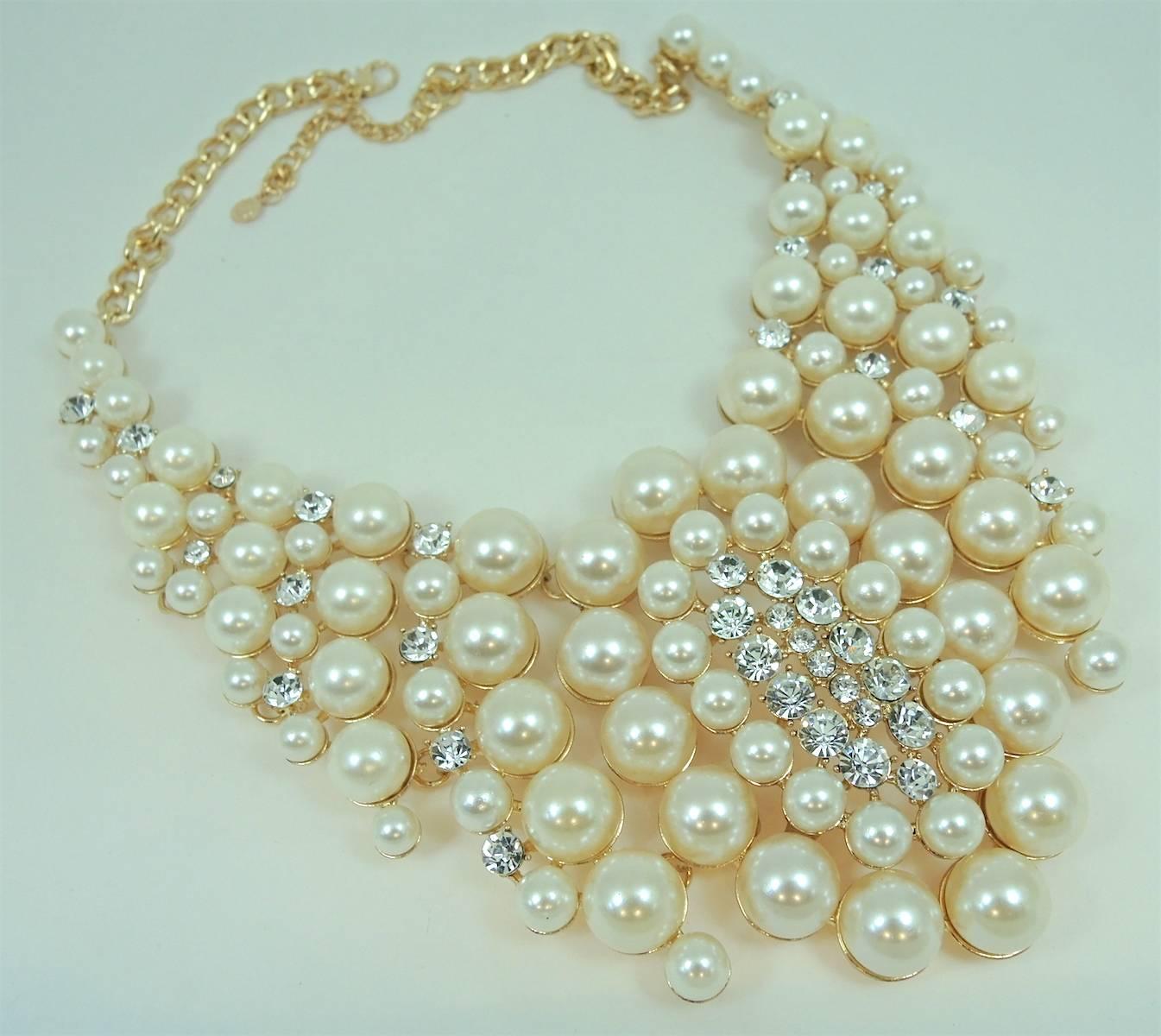 This chunky necklace was made and designed by Courrege, the great designer from France and I am delighted to have found it.  This necklace has segments of large faux cascading faux pearls and is set in a gold tone setting. It has an open link chain