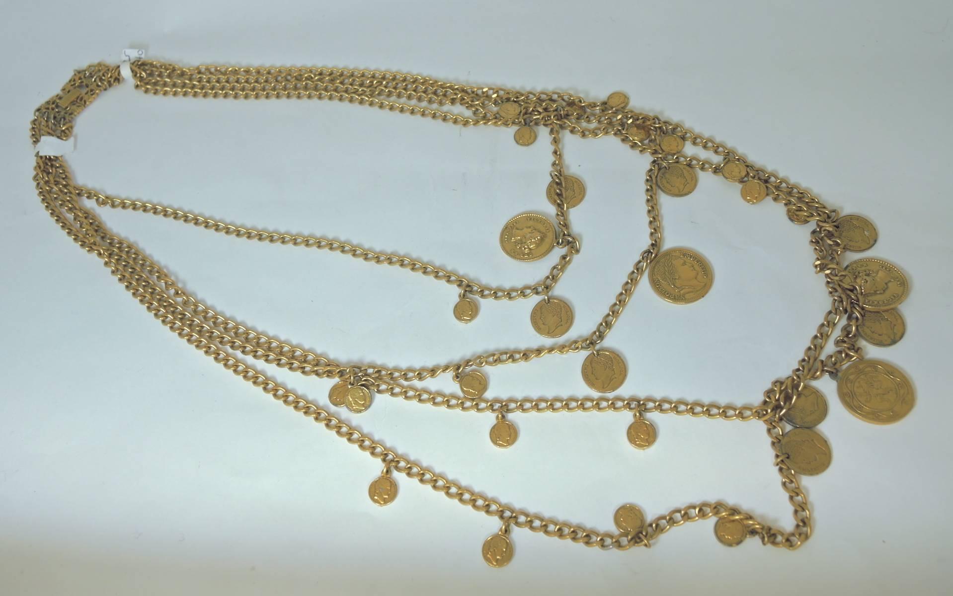 This Gorgeous vintage Goldette coin necklace features four chains designed with Victorian era coins. The measurements from longest to shortest chains are as follows: the longest measures 36” x 1/4”. The second measures 32” x 1/4”.The third measures