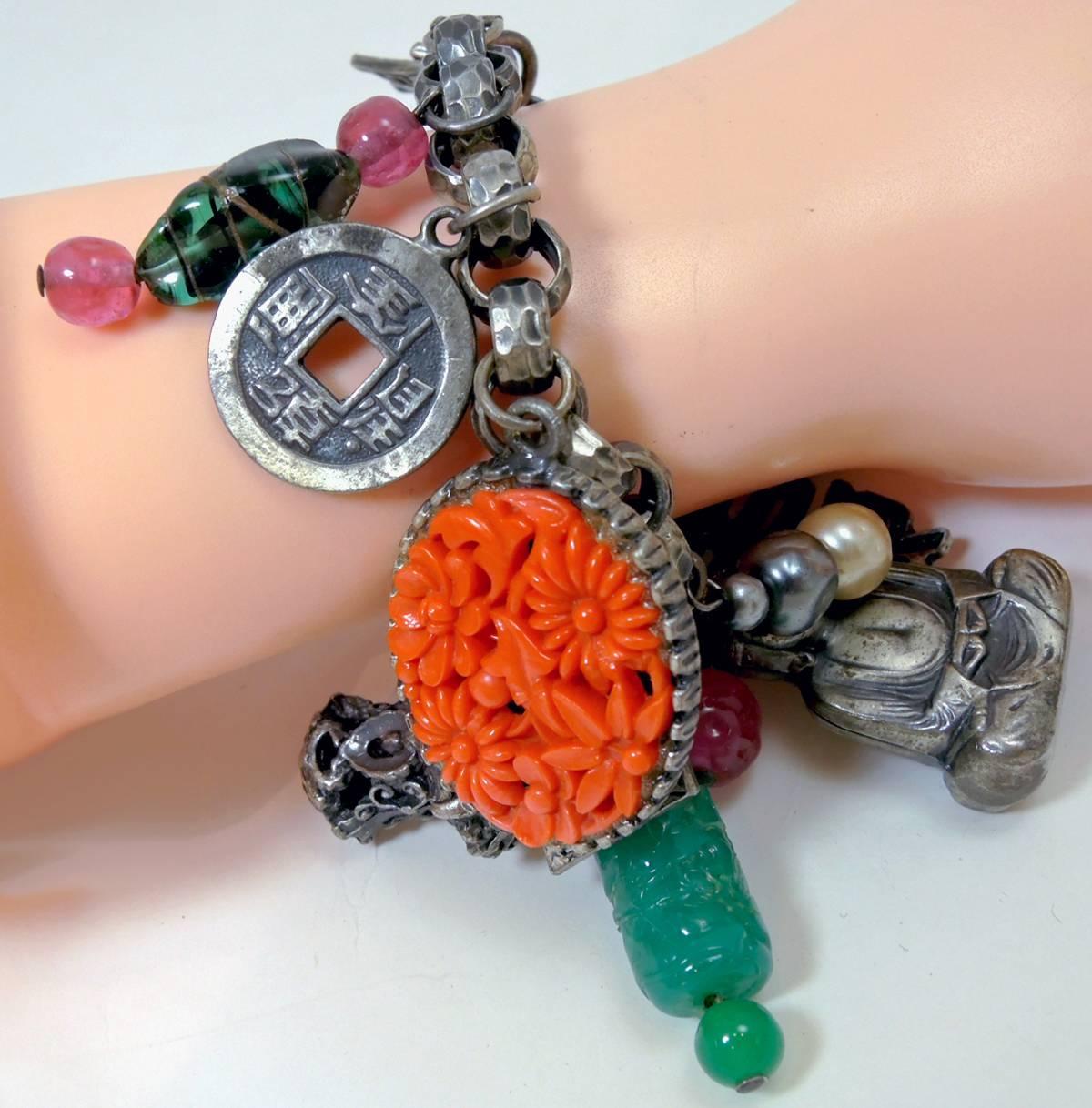 Napier is known for these beautifully creative charm bracelets. This one has fourteen different Asian inspired charms that measure from the longest at 1-3/4” to 1” These charms have glass beads and faux pearls all different with lots of detail. This