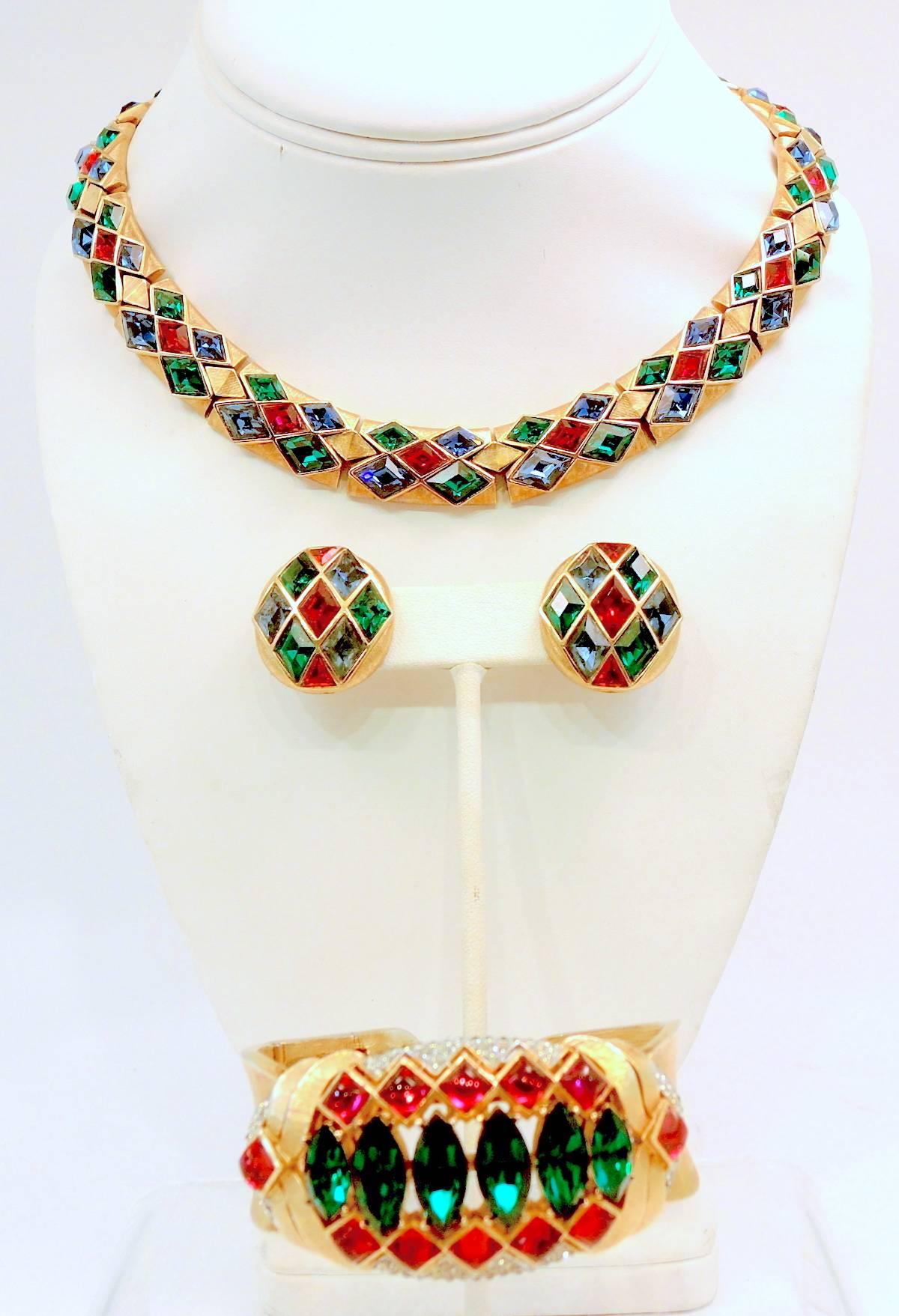 . Trifari created their own Moghul style, which is highly collectible especially when found together like this set. The necklace has segmented glass diamond shaped emeralds, rubies and sapphires. It is very flexible and comfortable to wear around