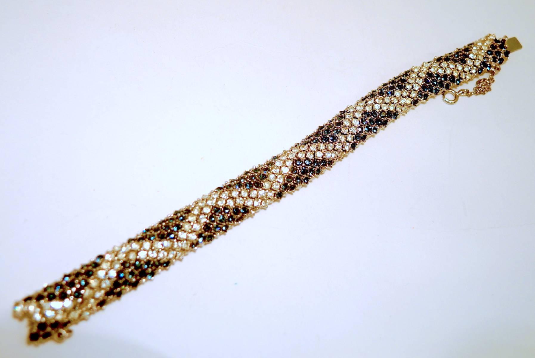 Although this bracelet is unsigned, it is attributed to Ciner for not only its look, but quality. It has faux sapphire rhinestones with a zigzag design of sparkling clear rhinestones. It has a slide in clasp and a safety chain. It measures 7” x 1/2”