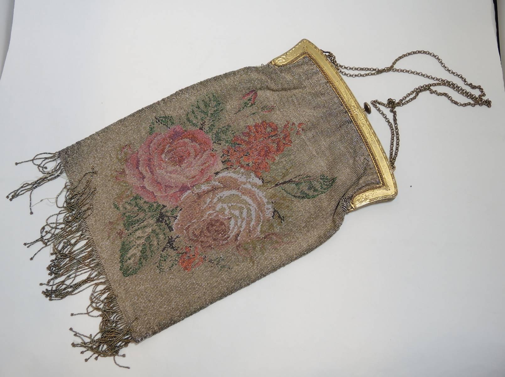 The design of this large purse is subtle and beautifully executed. You must know that the interior lining is not intact but still is original The fringe has some tiny beads missing. This purse measures 10” X 7-½” with a 2” fringe. This bag is in