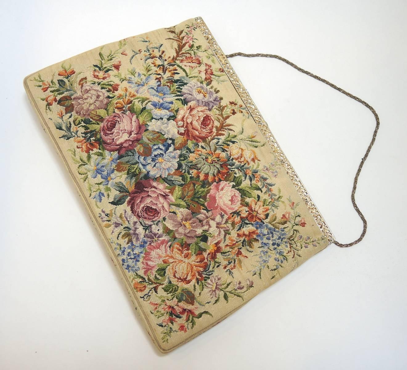 This tapestry purse is the best of vintage tapestries purses.  It is filled with muted multi-colored flowers that cascade into  a stunning pattern across the purse.  It measures 10” x 7” and is in excellent condition.