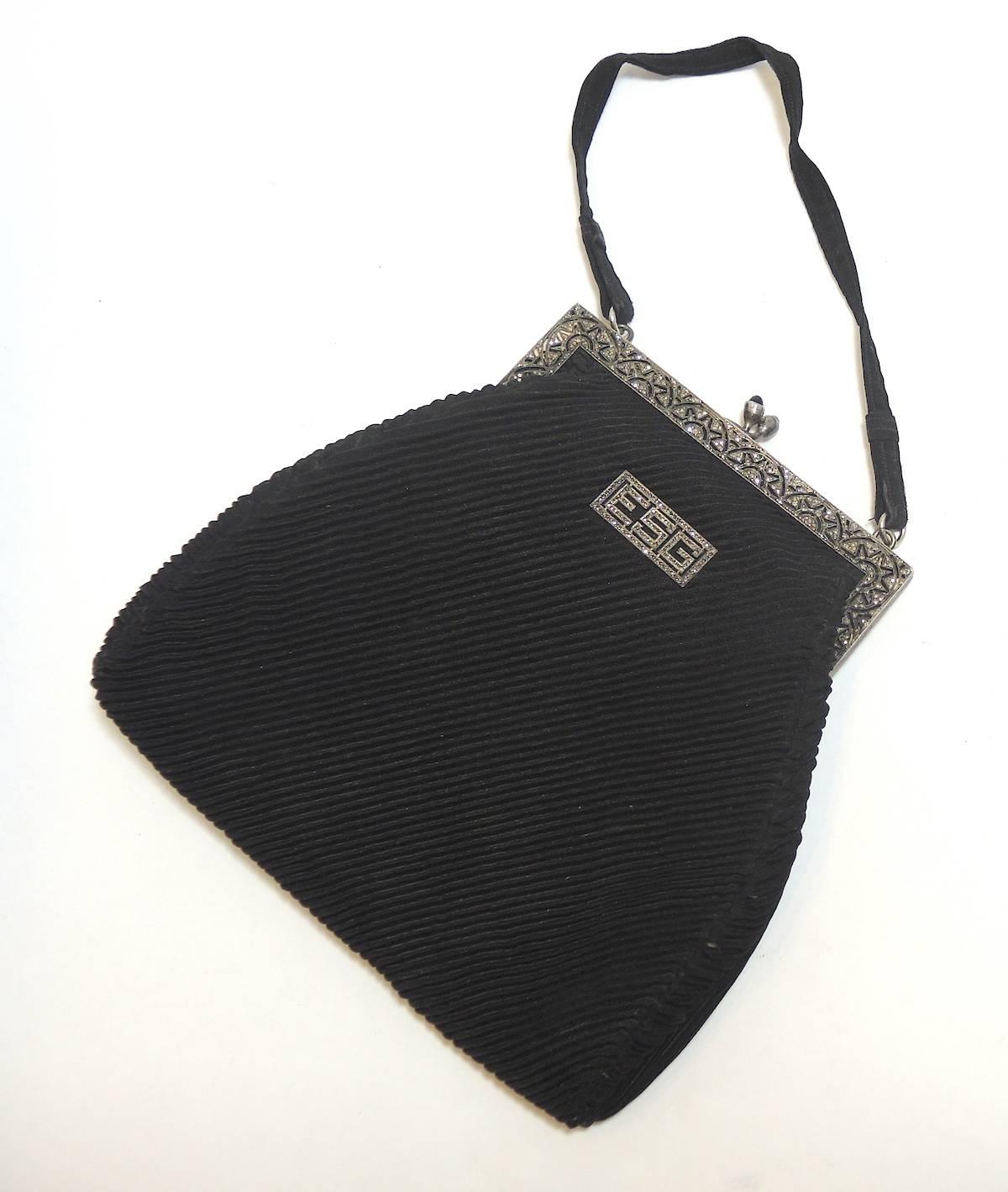 This is definitely one of a kind deco purse the fortuny pleated fabric is in excellent condition. The closure is done in marcasite and black onyx in a delicate deco design. There is a panel with the initials E.S.G Apparently for the lady that this