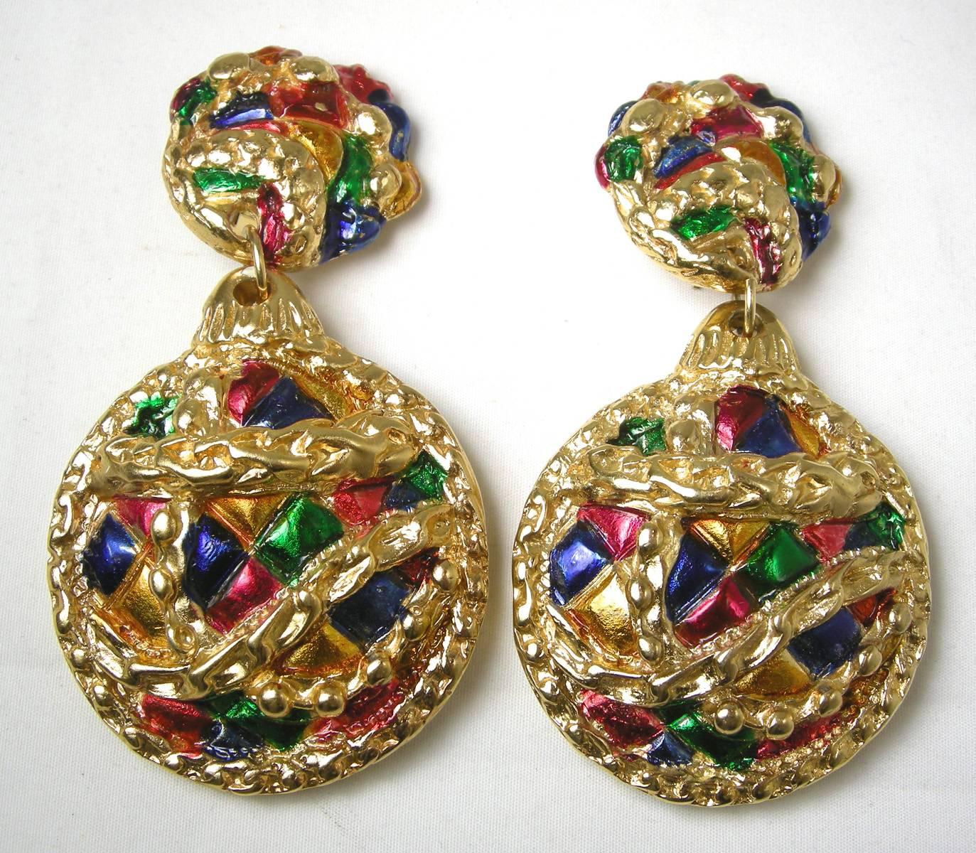These are a pair of amazing Jacky De G dangling earrings that has a intricate 3-dimensional design combining enameling and a gold tone setting. It has green, red, orange and yellow enameling with a swirl design. It measures 3-1/2” x 2”. It is signed