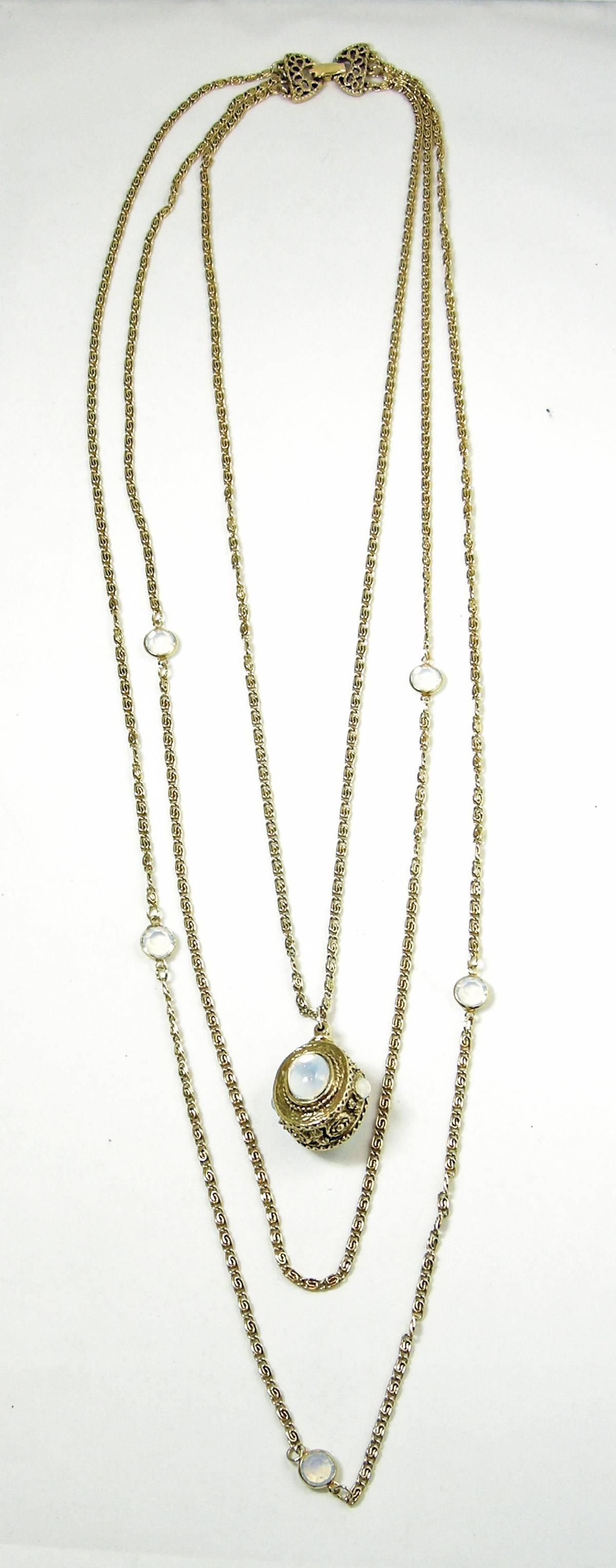 This is a 1950s vintage signed Goldette moonstone necklace that has 3 chains.  One chain has crystal moonstone accents.  The center has a faux moonstone cabochon set in an intricately designed pendant. The longest chain is approximately 36”. The