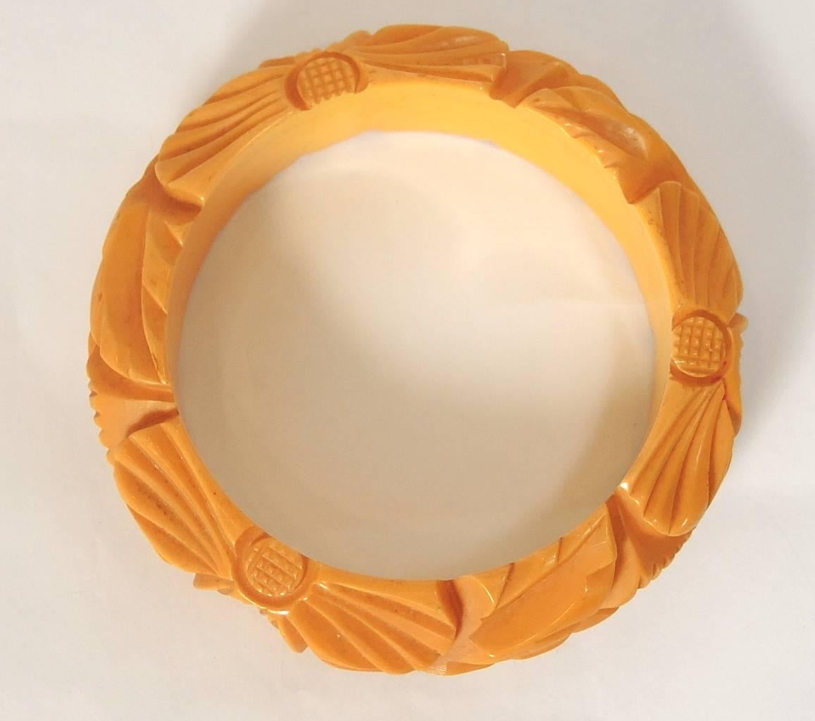 This vintage bangle bracelet features a carved leaf-like design in butterscotch Bakelite. This bangle bracelet measures 9” x 1” and is in excellent condition.