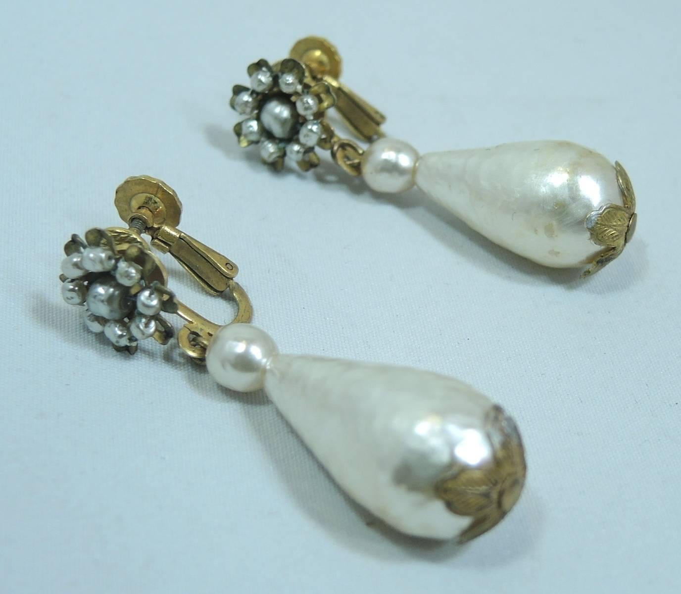 We are always looking for the long pearl drop earrings designed by Miriam Haskell. They are always desirable and highly collectible. These earrings are made in a gold tone setting and measure almost 2” L x 1/2” w. They are signed “Miriam Haskell”