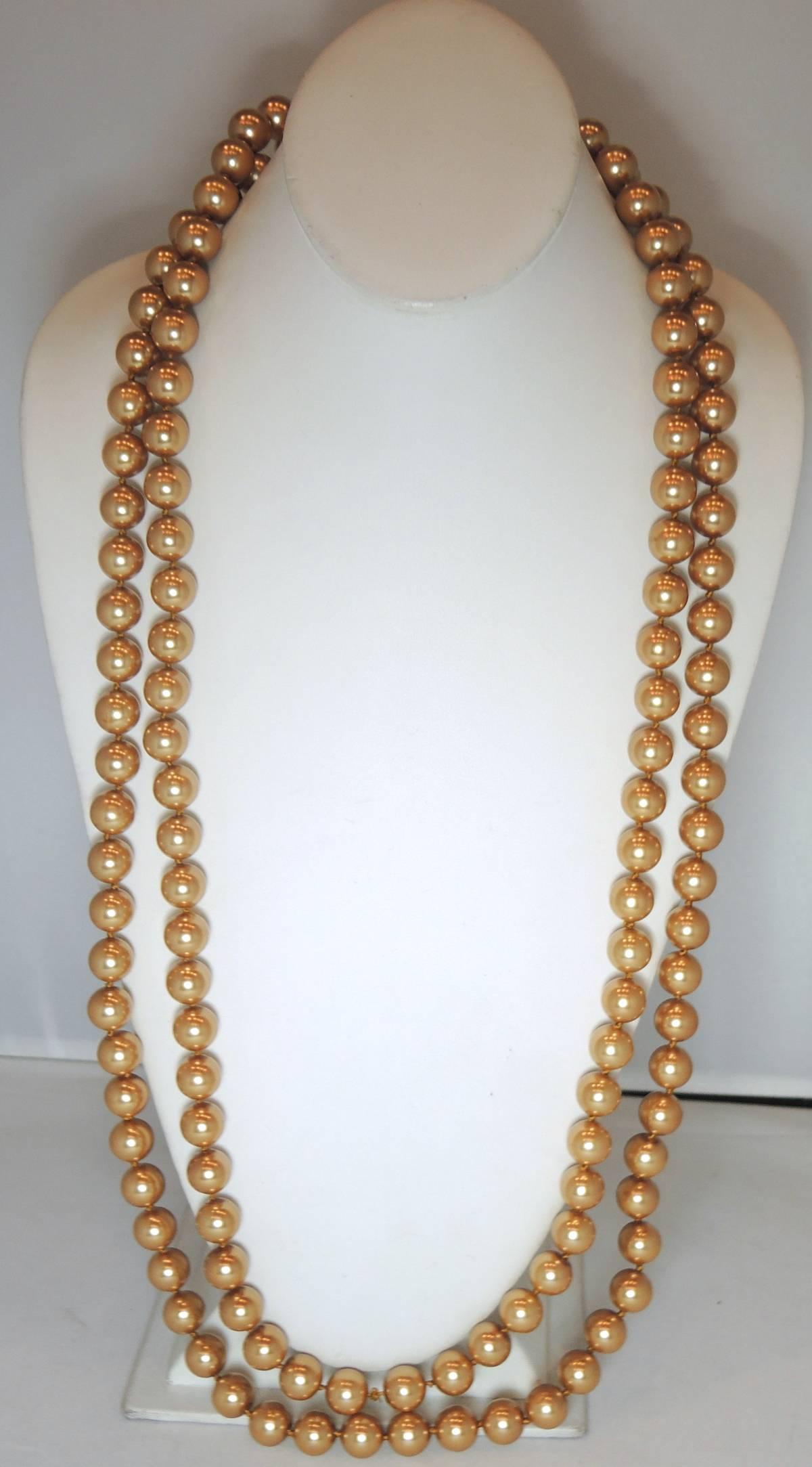 Many years ago, costume pearls were first made of glass in France and then shipped to Japan for the pearl covering.  We don’t see them too often now.  Yet, this extremely long necklace was created with faux champagne glass pearls that reminds me of