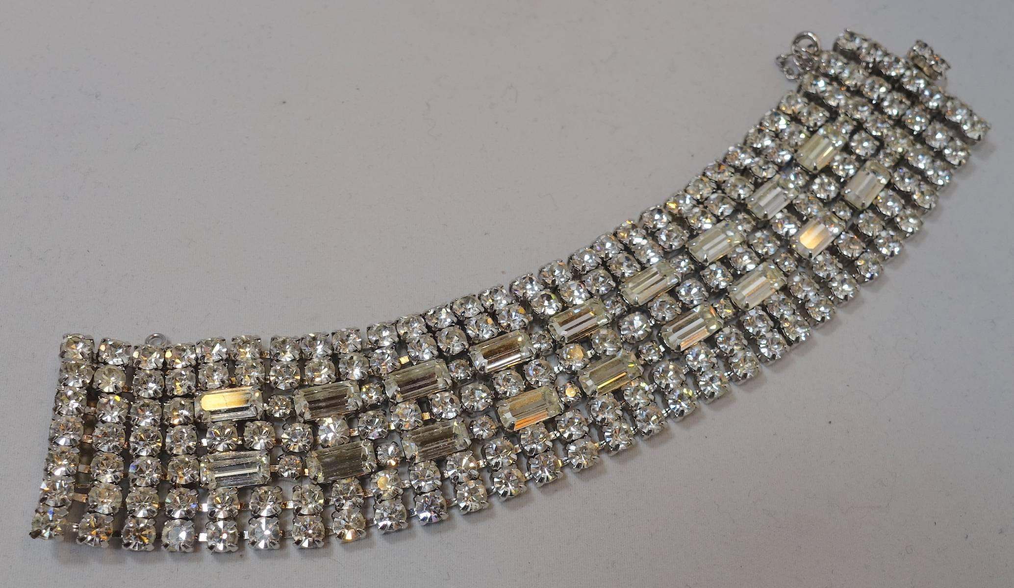 People are always looking for this bracelet.  Kramer made his jewelry to look real and this is no exception. It is wide and is filled with prong set crystals with two rows of crystal baguettes streaming down the middle. It has a slide in clasp in a
