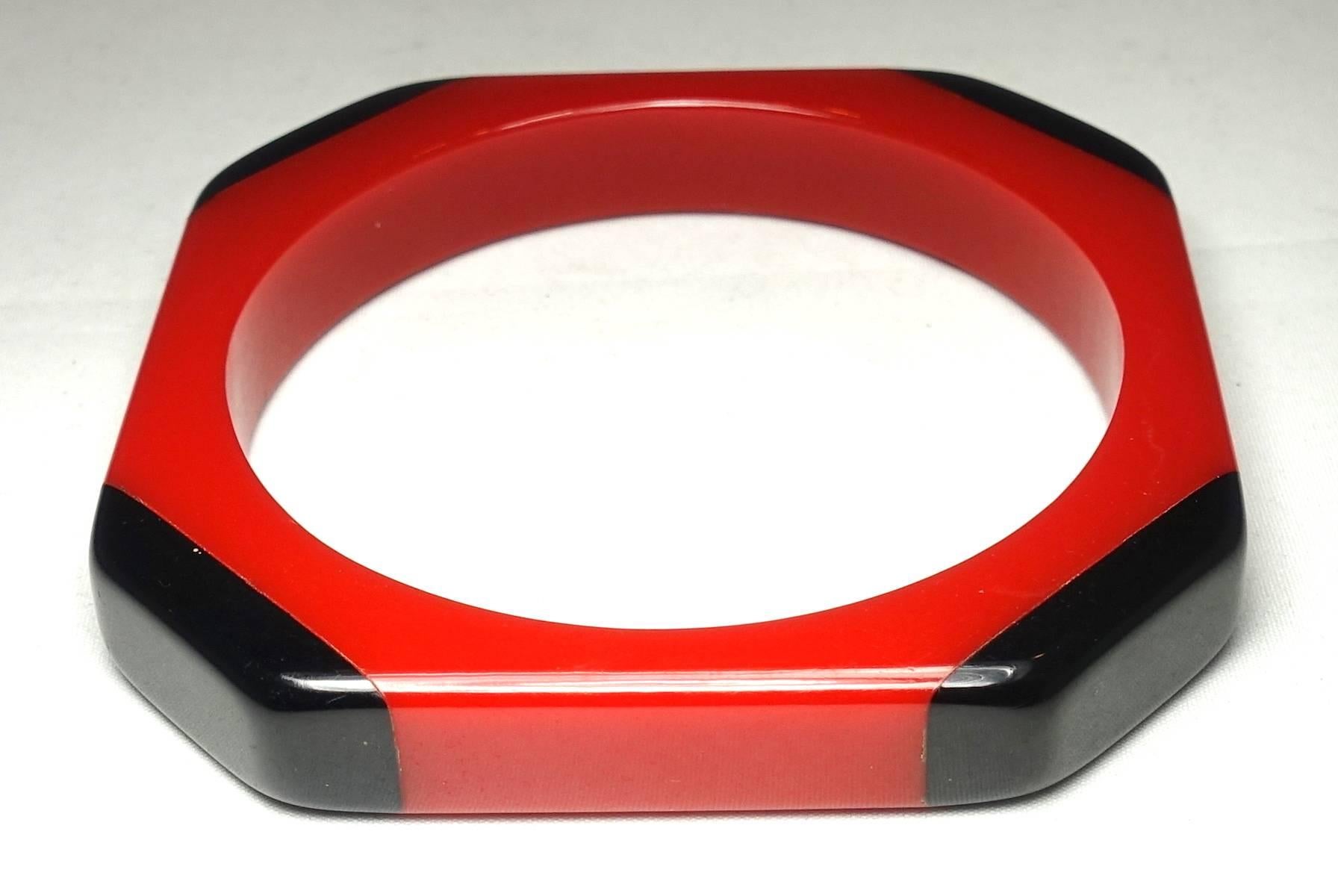 This 1940s vintage Bakelite bangle bracelet features a unique red & black design. In excellent condition, this highly collectible piece measures 3-1/4” x 1/2” and can fit up to a 7-1/2” wrist. 