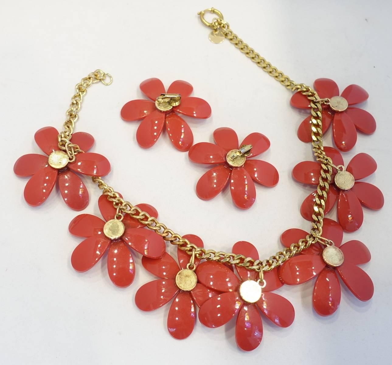 This is a one-of-a-kind original Anka design and features stunning raspberry color resin flowers with a faceted crystal in the center of each flower. The necklace measures 20” x 2-1/2” with a spring closure in a gold tone setting. The matching clip
