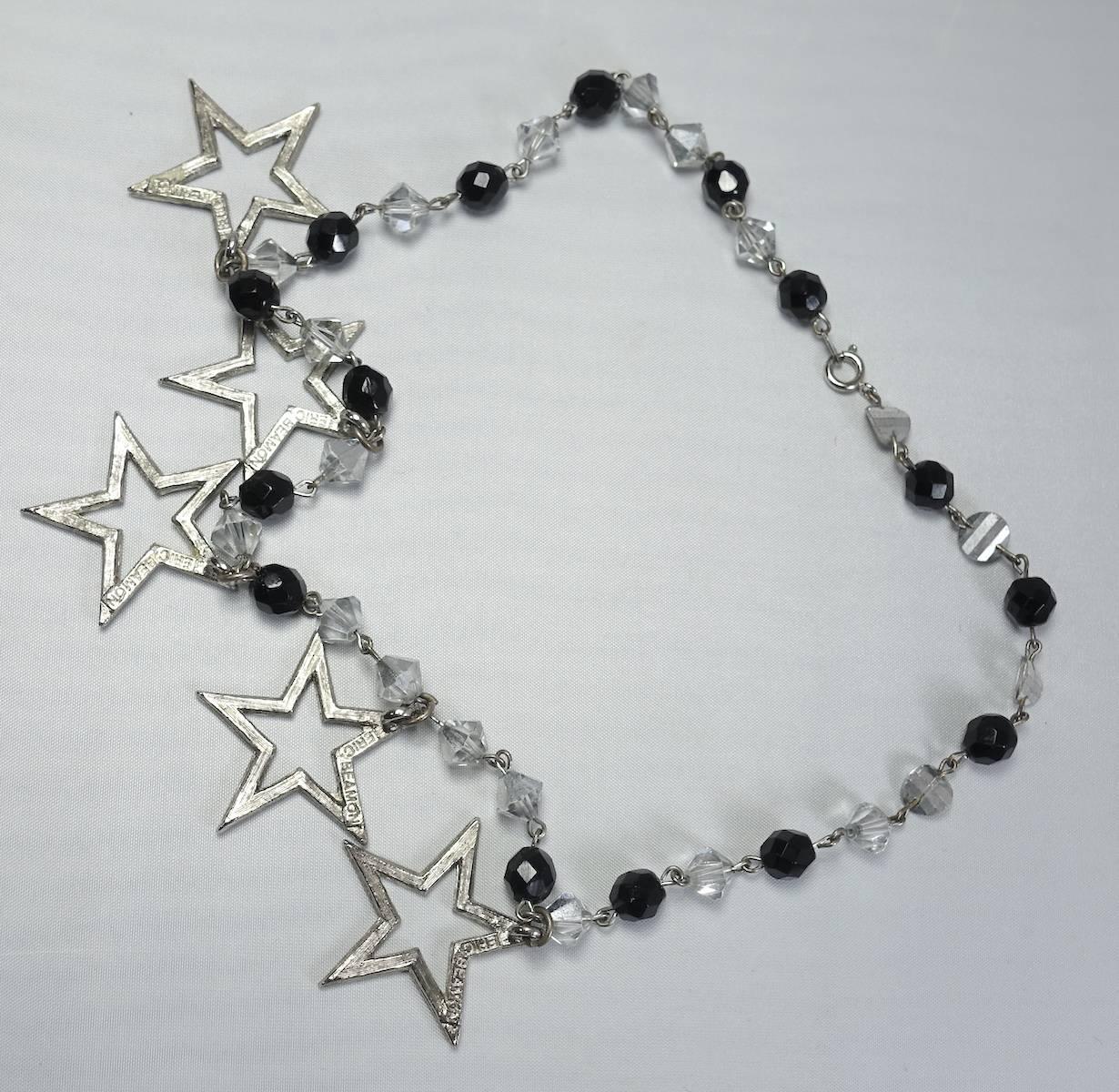 This vintage 1970s necklace features multiple stars with clear crystal accents in a silver tone setting.  In excellent condition, this necklace measures 18” long and each star is 1-1/2”.