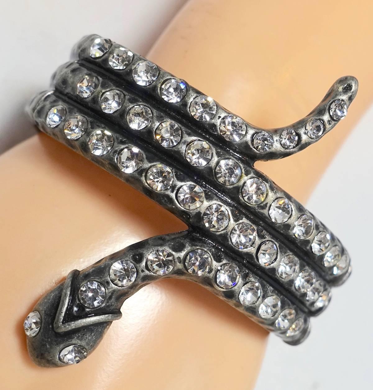 I was lucky to find two of these … one for each wrist for those who want to make a fashion statement. This dramatic stretch bracelet features a snake-serpent design with clear crystals in a heavily carved silver tone setting.  In excellent