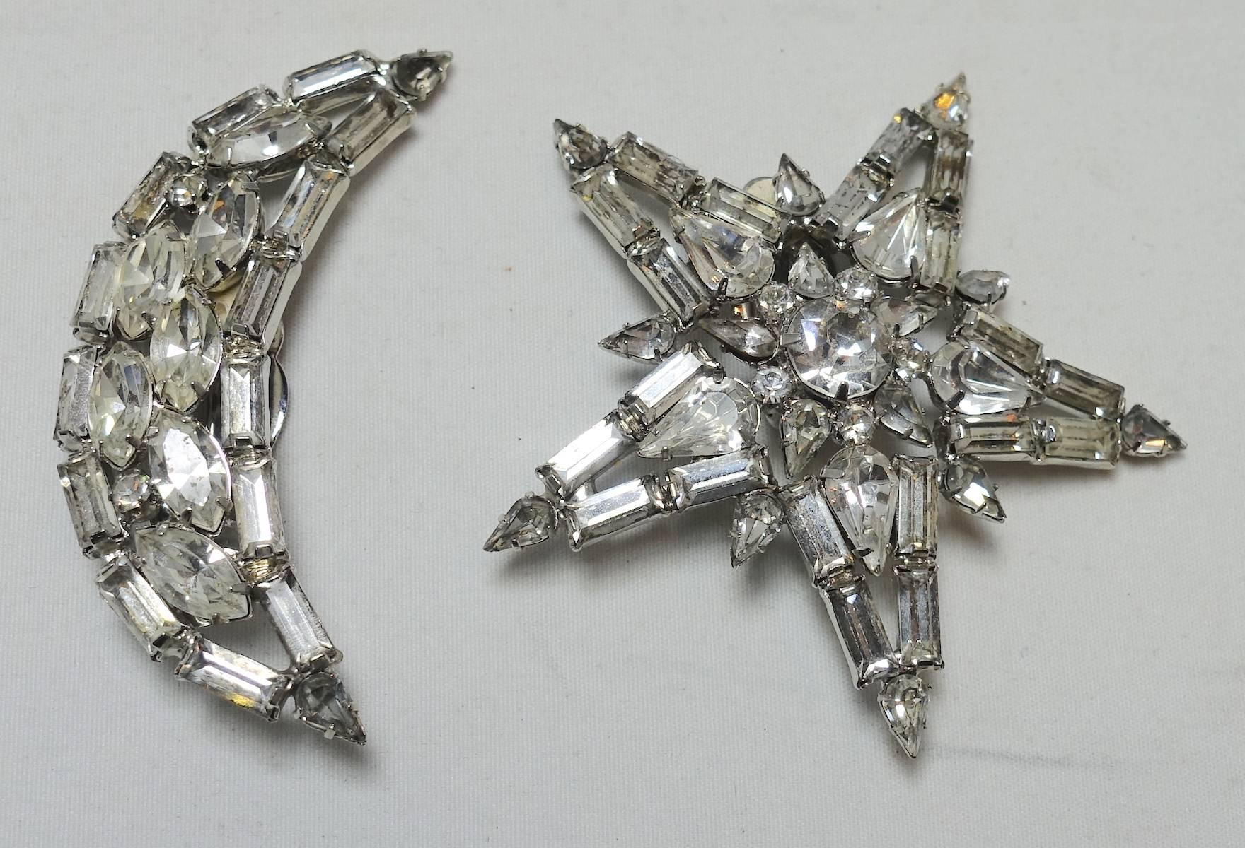 These Kirks Folly earrings are fun to wear. They feature a star with crystals for one ear and a half moon with crystals for the other.  They are in a silver tone setting.  The star measures 2-1/4” and the half-moon is 2-1/4” x 5/8”.  These earrings