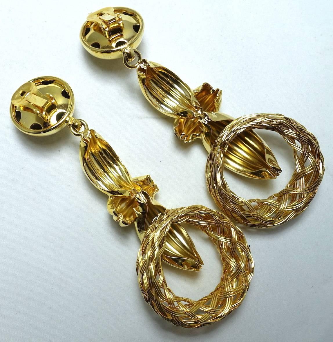 These earrings are so 80s! They have a large button top that connects to an elongated ribbed gold tone dangle with a basket weave circle at the bottom. These stunners measure a whopping 4-1/2” x 2” and are in excellent condition.