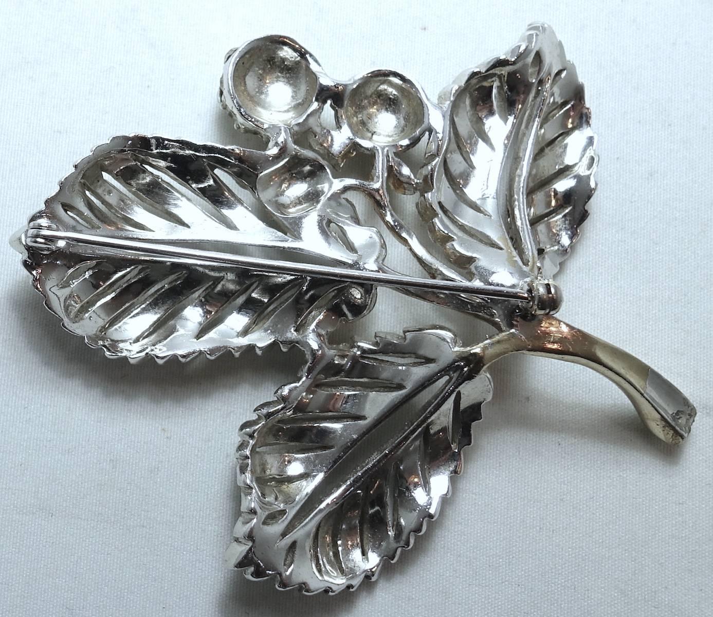 This beautiful Alua brooch features a leaf design in a mixed-metal setting. This brooch measures 3” x 3” and we believe it is signed “Alua” although it looks like a “Reja” design.  It is in excellent condition.