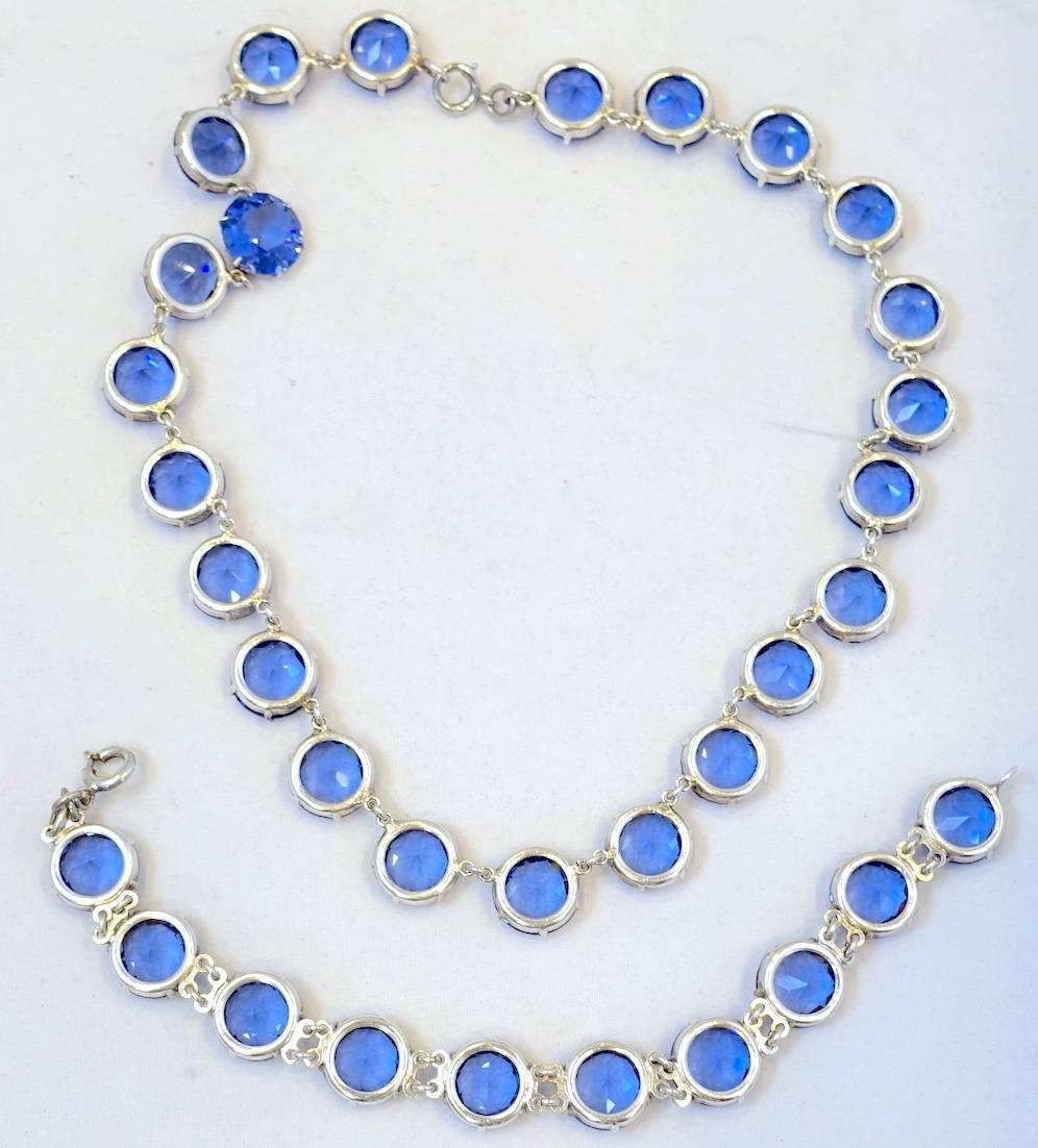 This is a fabulous 1930s Czech set with vibrant blue open-back faceted prong-set crystals in a sterling silver setting. The necklace measures 15” x 1/2