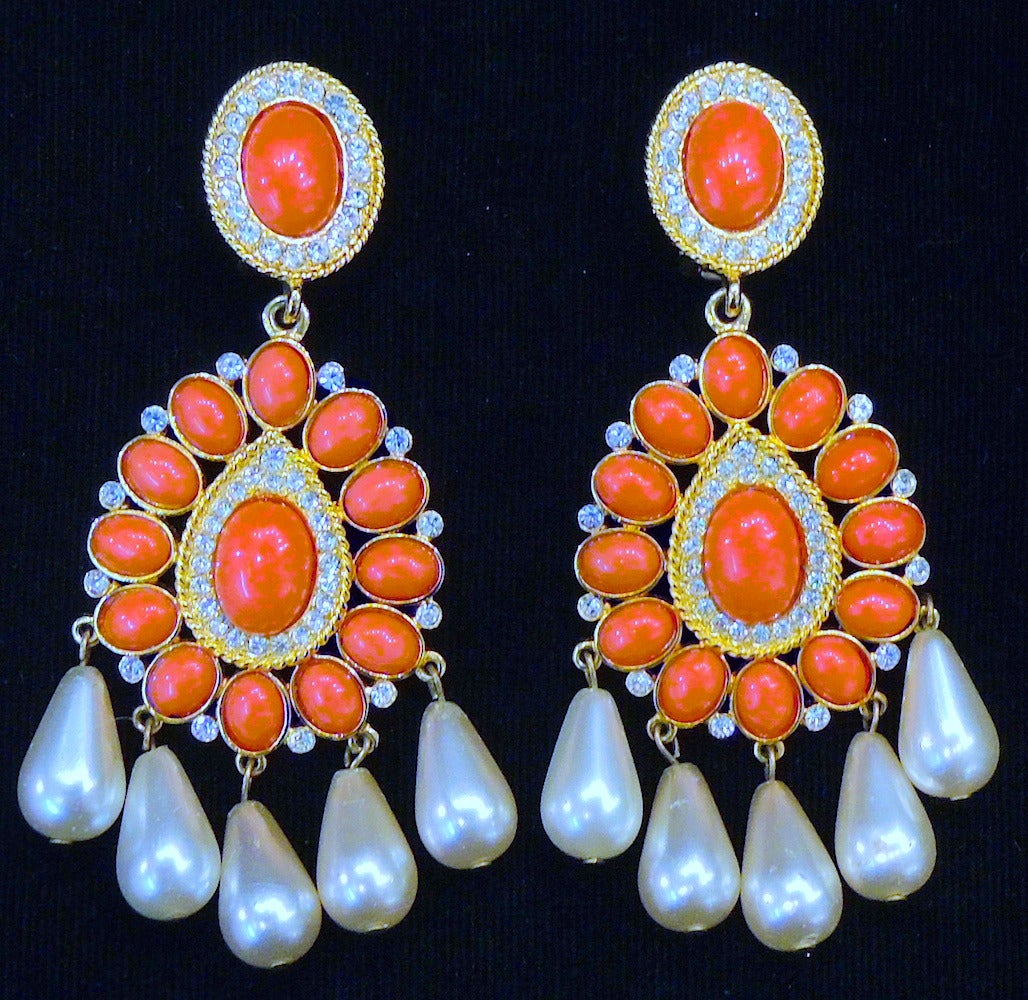 These signed KJL earrings feature faux coral and pearls with clear rhinestone accents in a gold-tone setting.  These clip earrings measure 3 7/8” x 1 5/8”, are signed “KJL” and are in excellent condition.