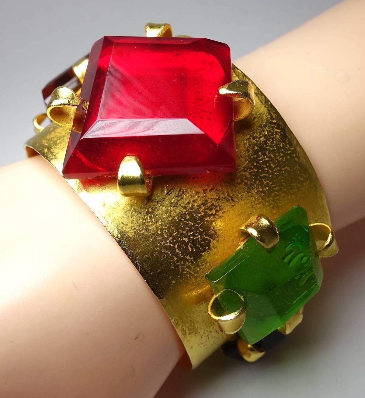 This gorgeous cuff by French designer Dominique Aurientis features large bezel cut glass tones in colors of garnet, amethyst, topaz, citrine & peridot, all in a textured gold tone setting.  This cuff measures 7-1/2” x 1-5/8” and is signed “Dominique