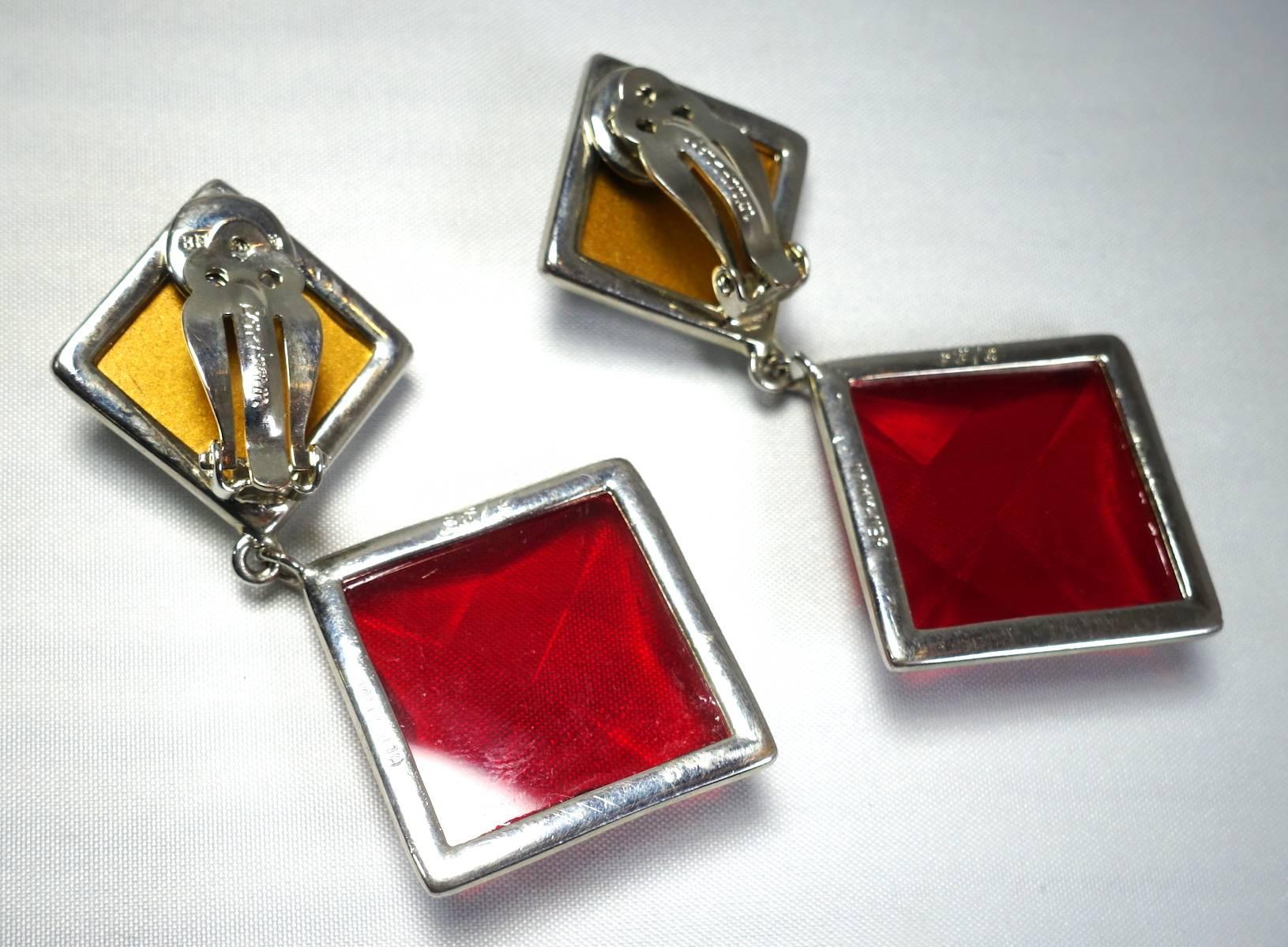 This stunning vintage signed Ben Amun earrings feature large red and clear stones in a silver tone setting.  These clip earrings measure 3” x 1-1/2” and are signed “Ben Amun”. They are in excellent condition.