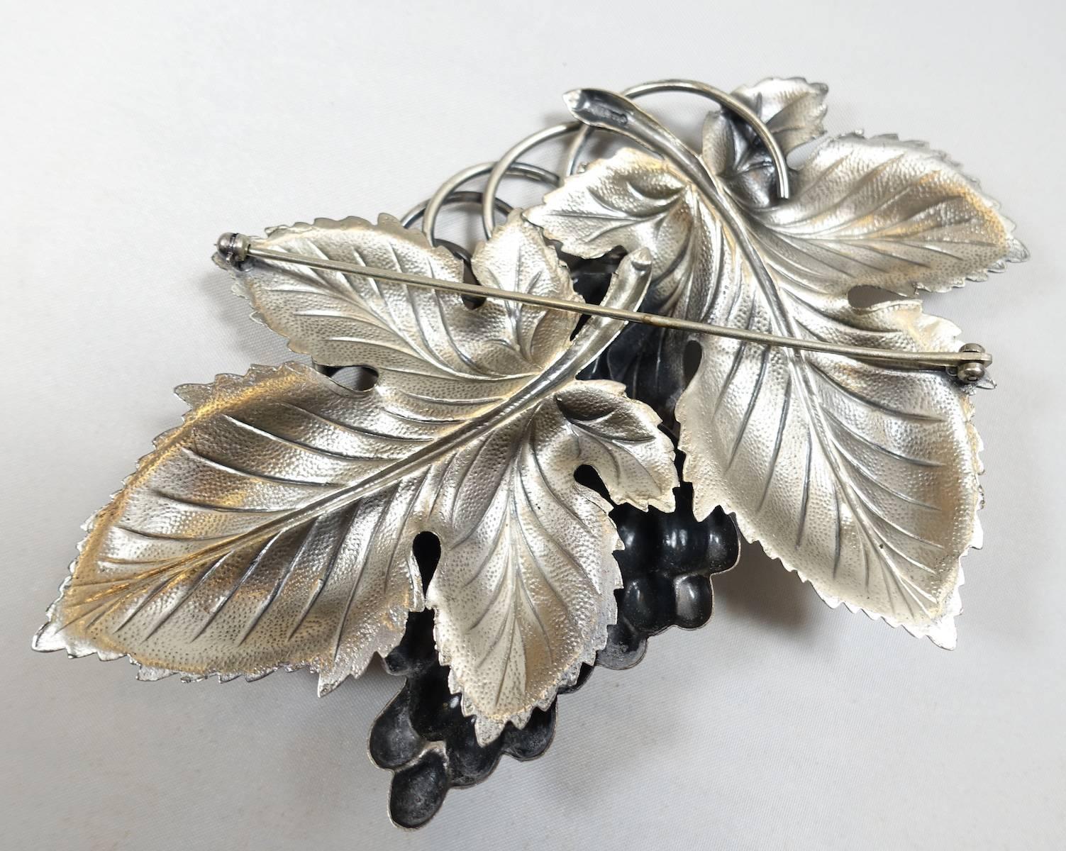This is the famous huge Napier grape leaf brooch, known to be one of Napier’s most popular designs and collectors love them!  It’s made of silver plated brass. It measures 3-1/8” x 5” and is signed “Napier”.   It is in excellent condition.