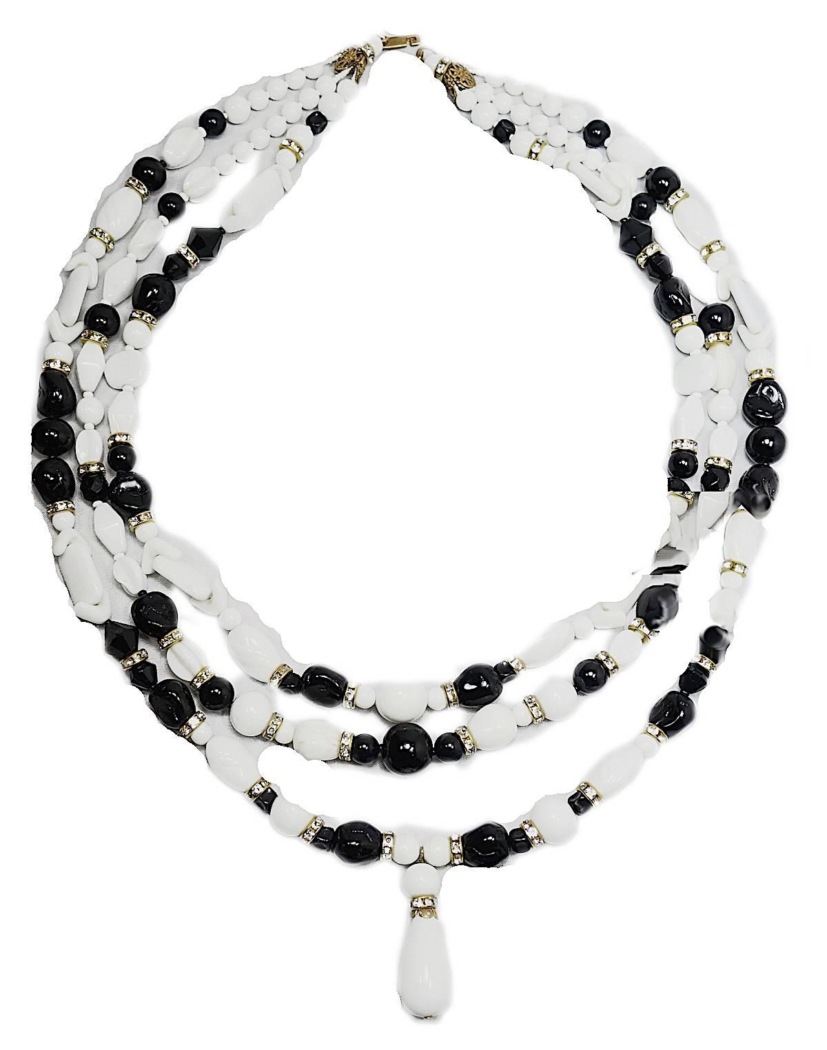 This Miriam Haskell necklace features black and white glass beads in a gold tone setting.  The longest strand is 25” x 1/2”; the shortest 20” x 1/2”. There is a teardrop shaped glass bead at the drop that measures 1-1/2” x 1/2”. This necklace is